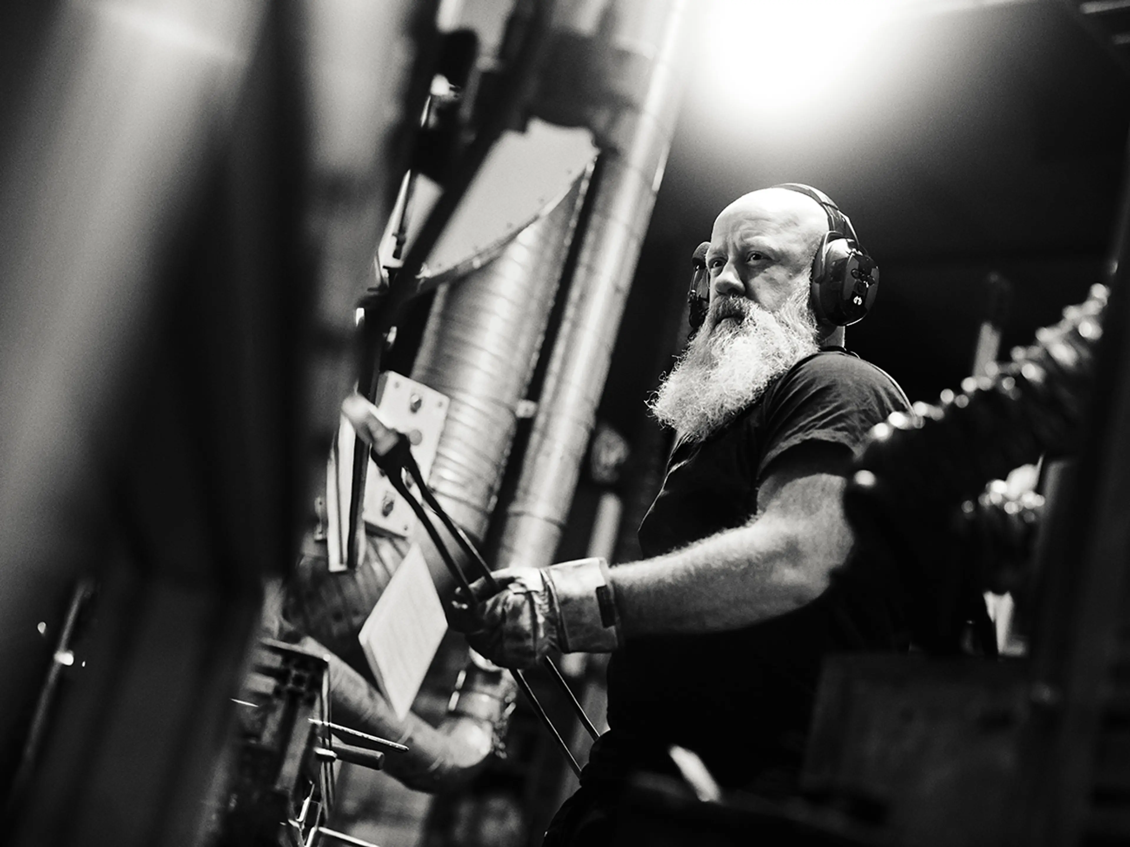 mann med skjegg og hørselvern Fra Hellberg jobber med en lang tang