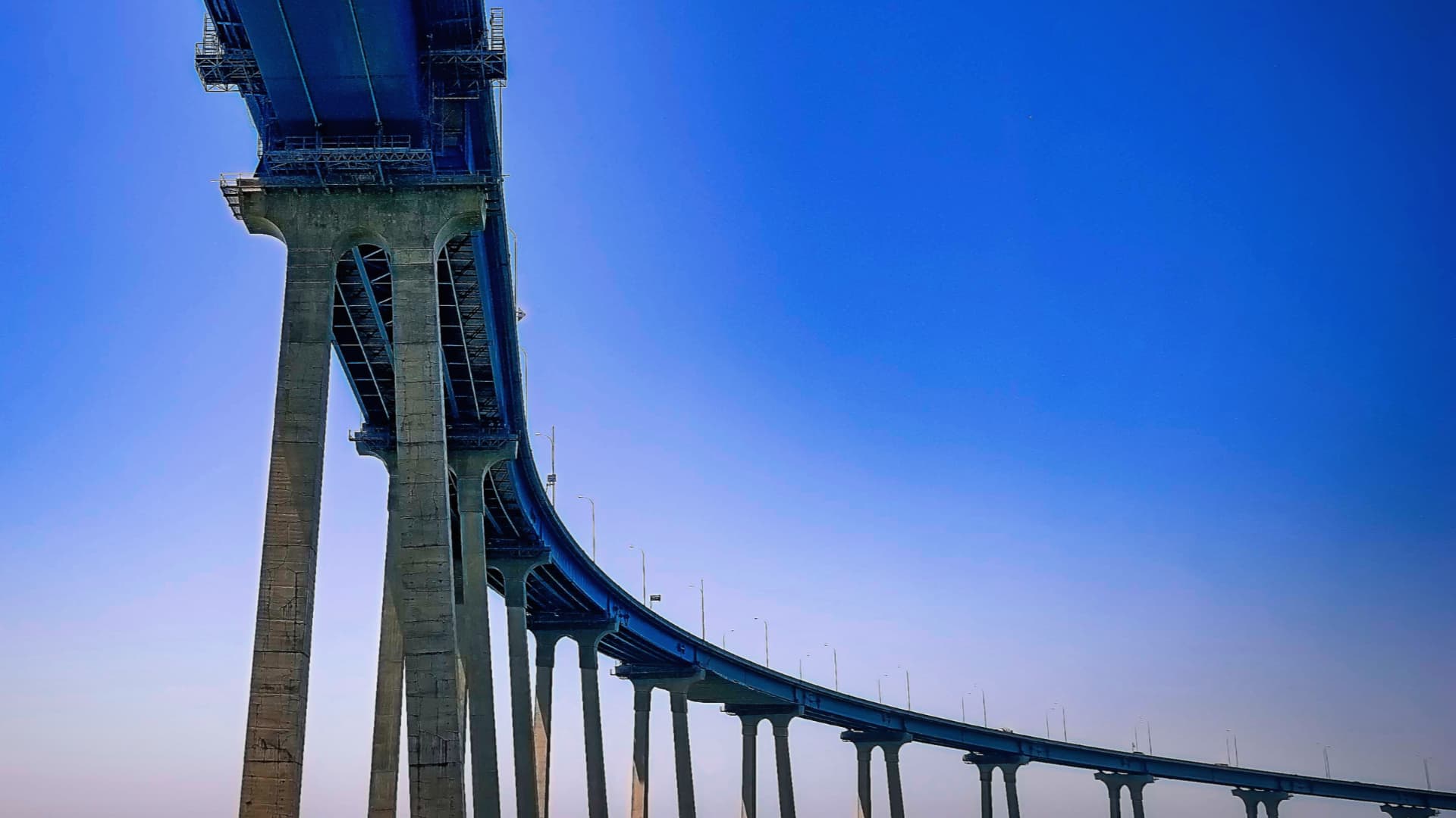 Photograph from the the bottom of a long freeway bridge.