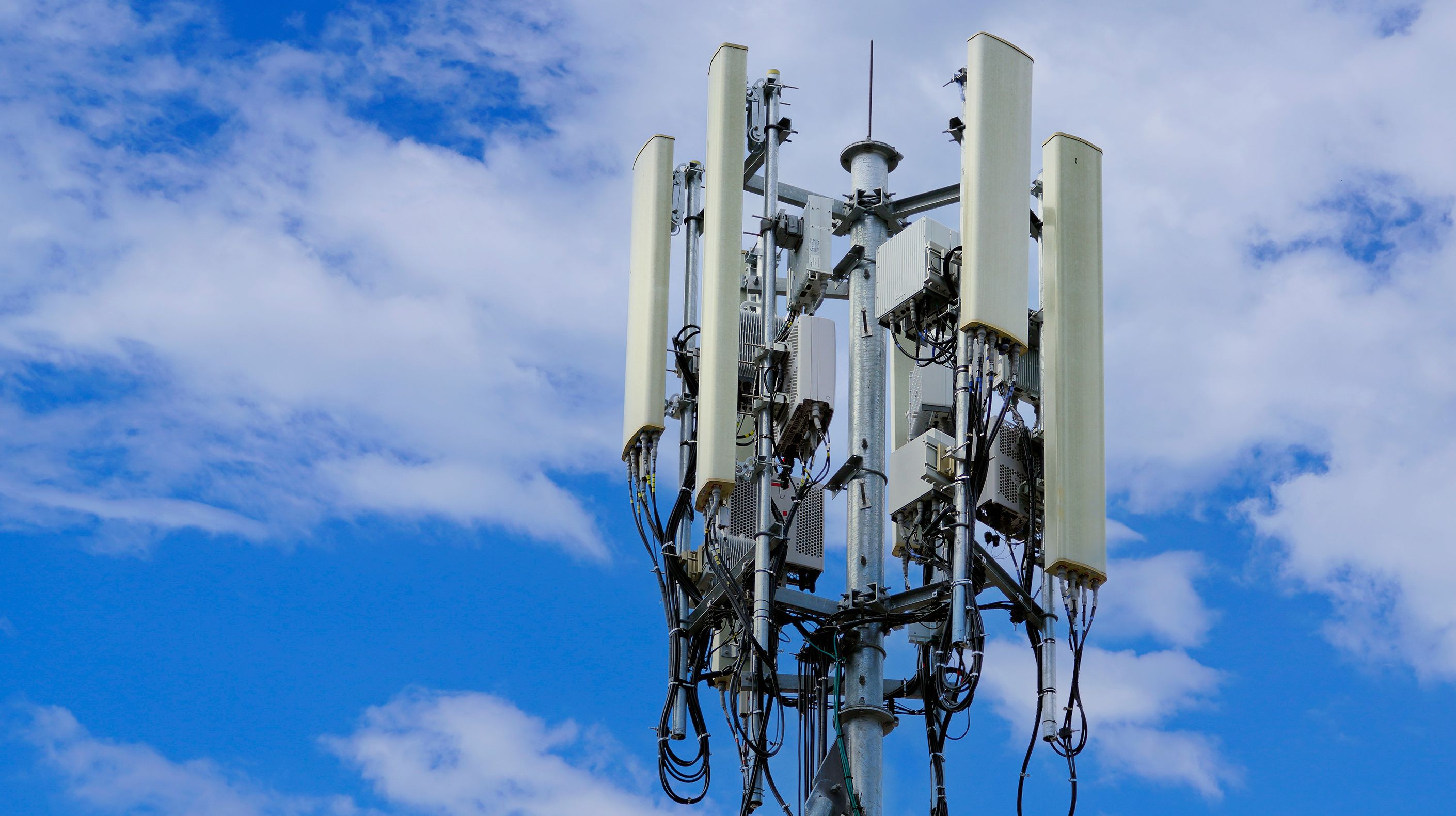 Close up of a 5G cell tower with the sky as a backdrop.