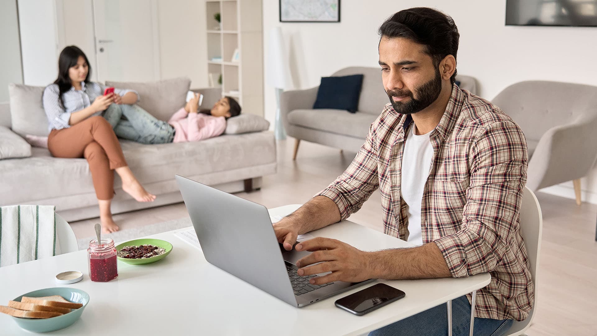 Employee doing remote work from home in their living room.