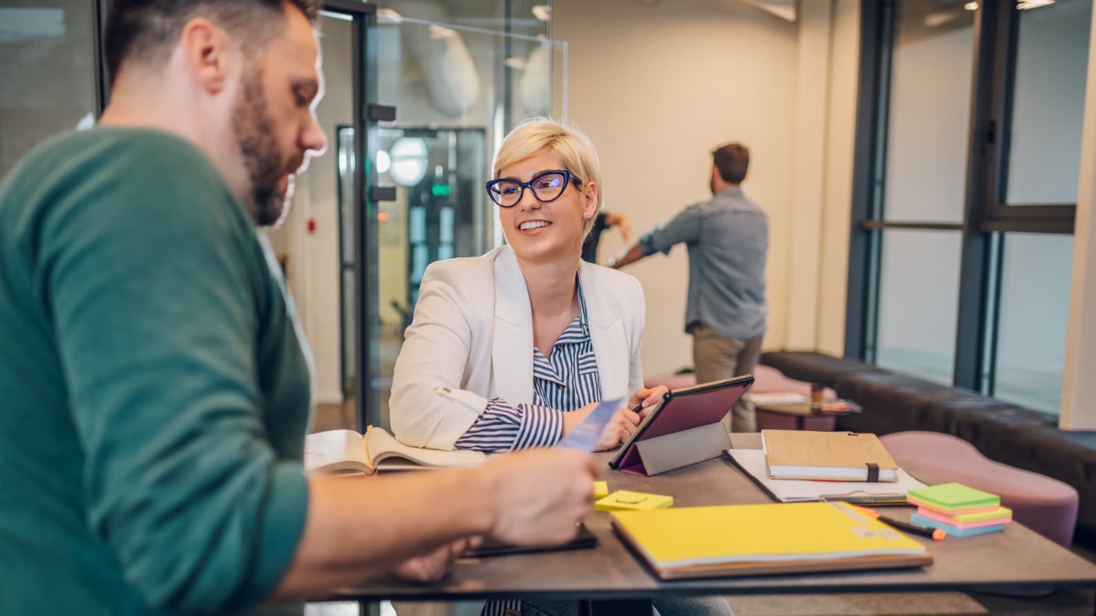 Two people discussing a topic within a coworking space.