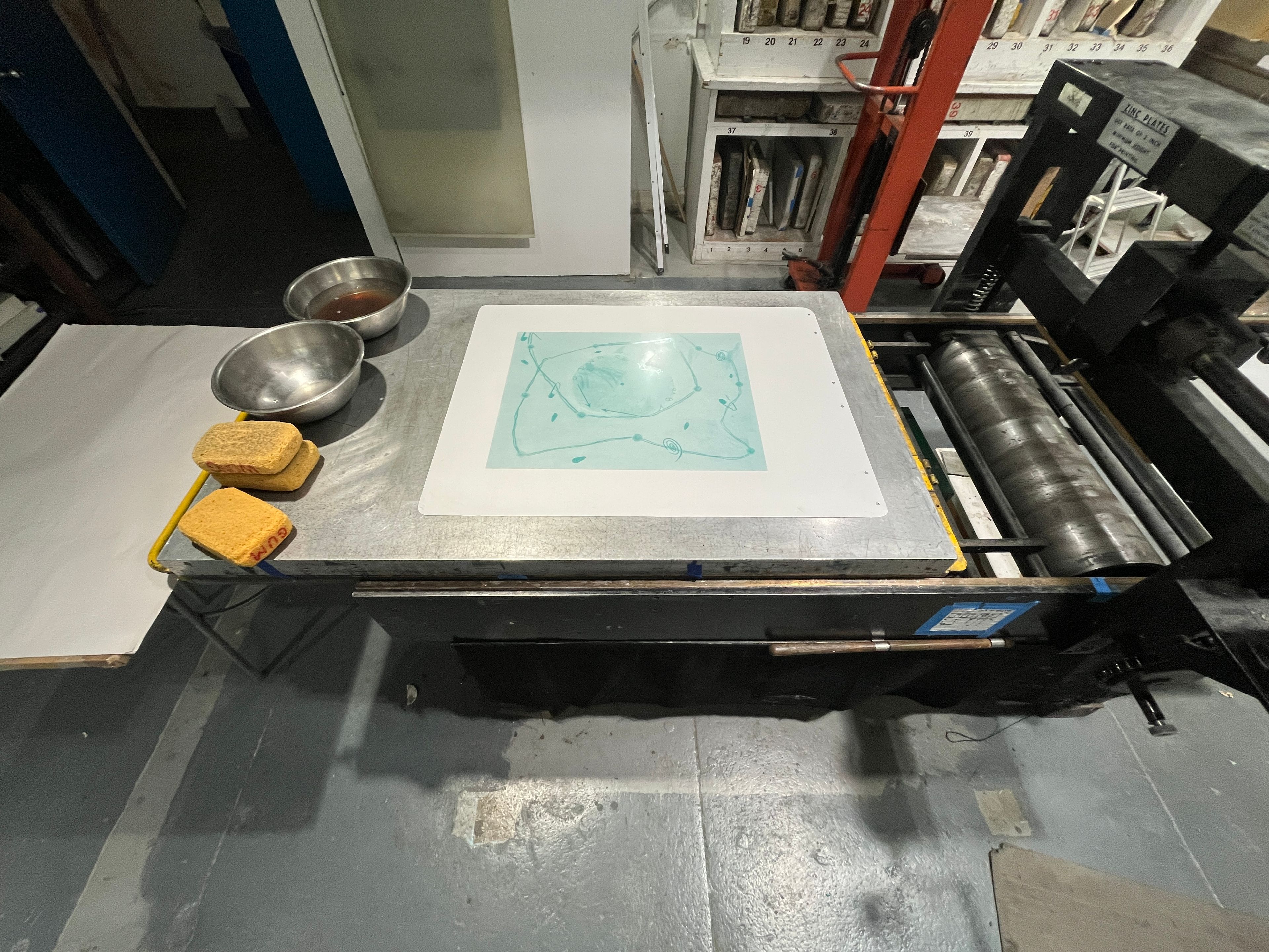 an aluminum plate on a lithographic press