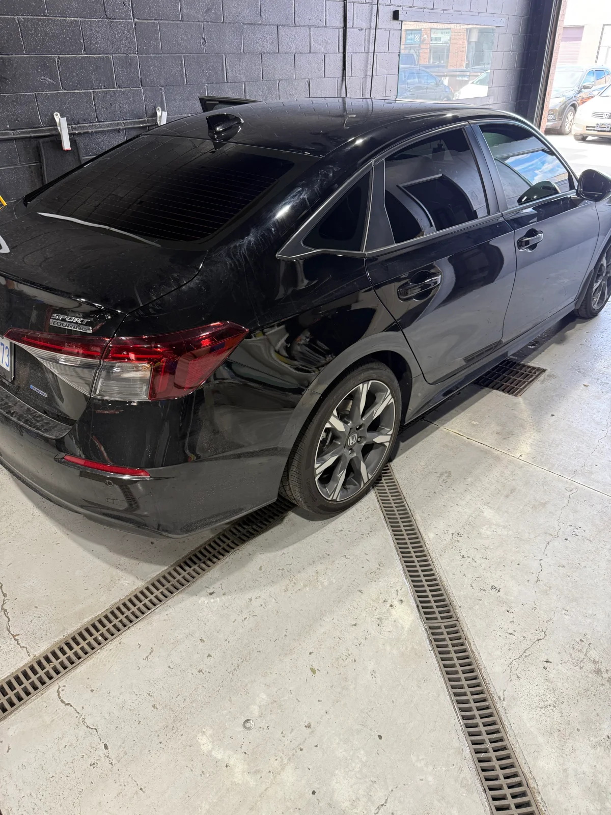 High-gloss professional car detailing and window tint on a black Honda Civic at Beyond Detail in Scarborough.