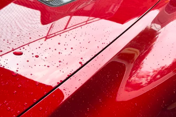 Car hood showing hydrophobic water beading after professional ceramic coating at Beyond Detail Scarborough.