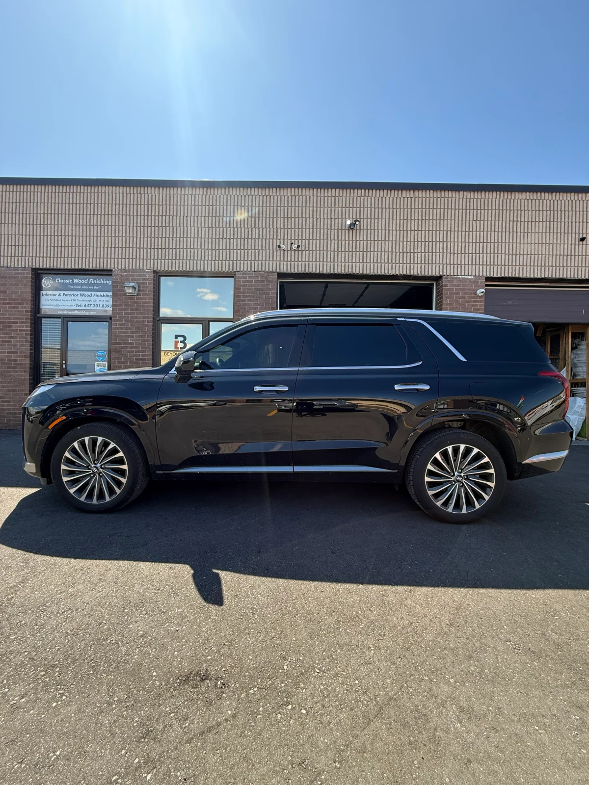 Luxury sedan with professionally installed window tint outside Beyond Detail Scarborough, showcasing high-quality ceramic film and heat rejection.