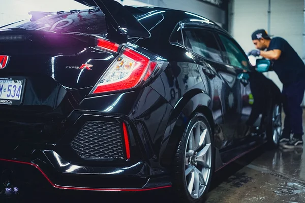 Detailing technician performing a professional exterior hand wash on a black Honda Civic at Beyond Detail Scarborough.