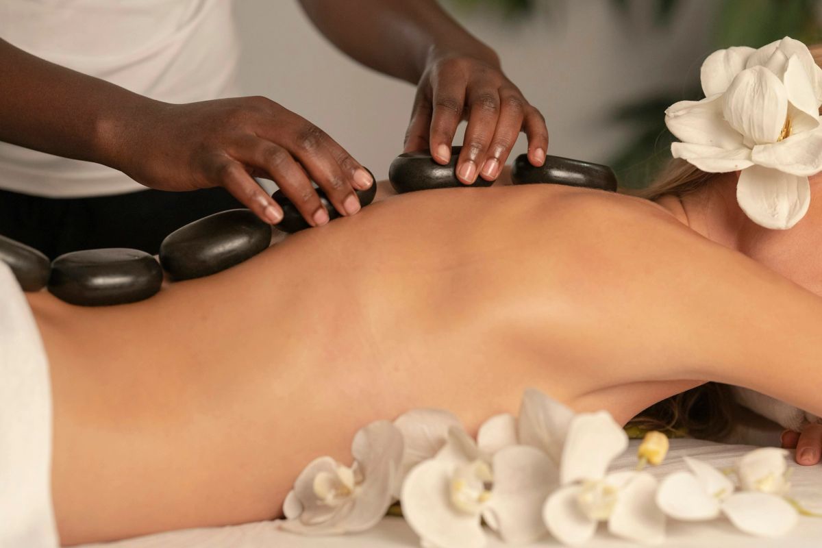 A hot stone massage with white flowers