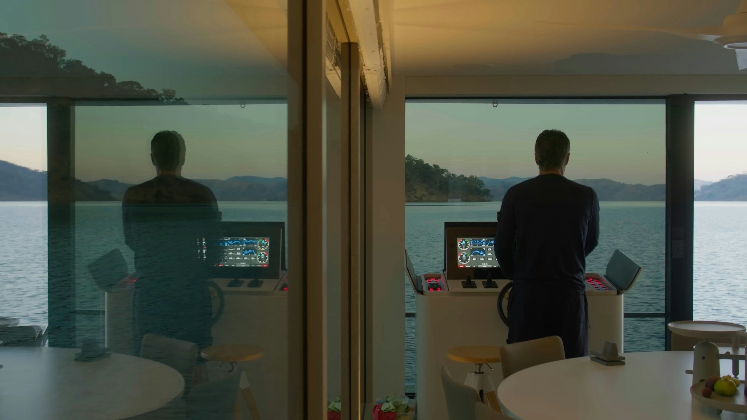 A guest looking out to sea from a yacht salon