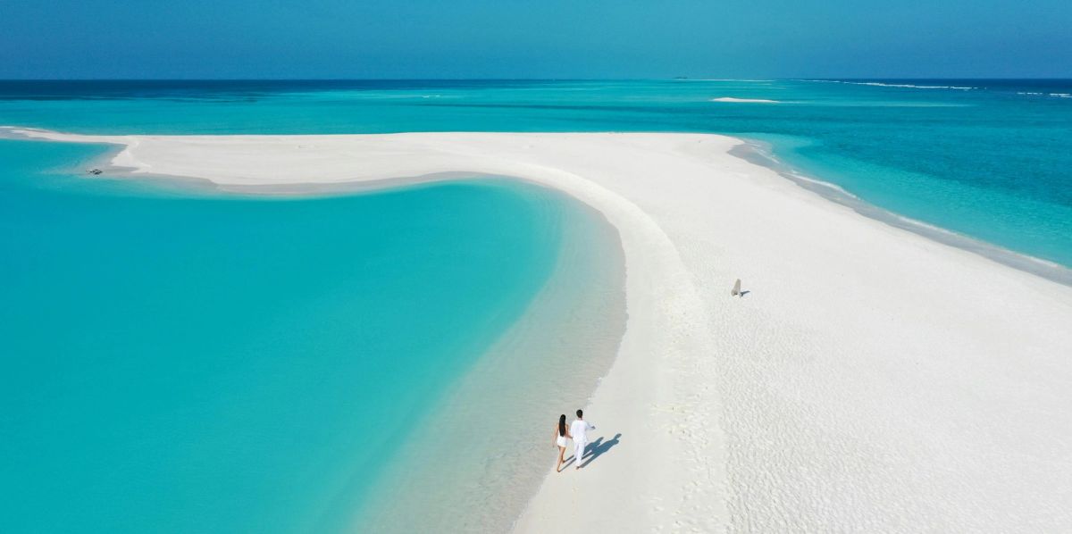 A couple on a white sandbar