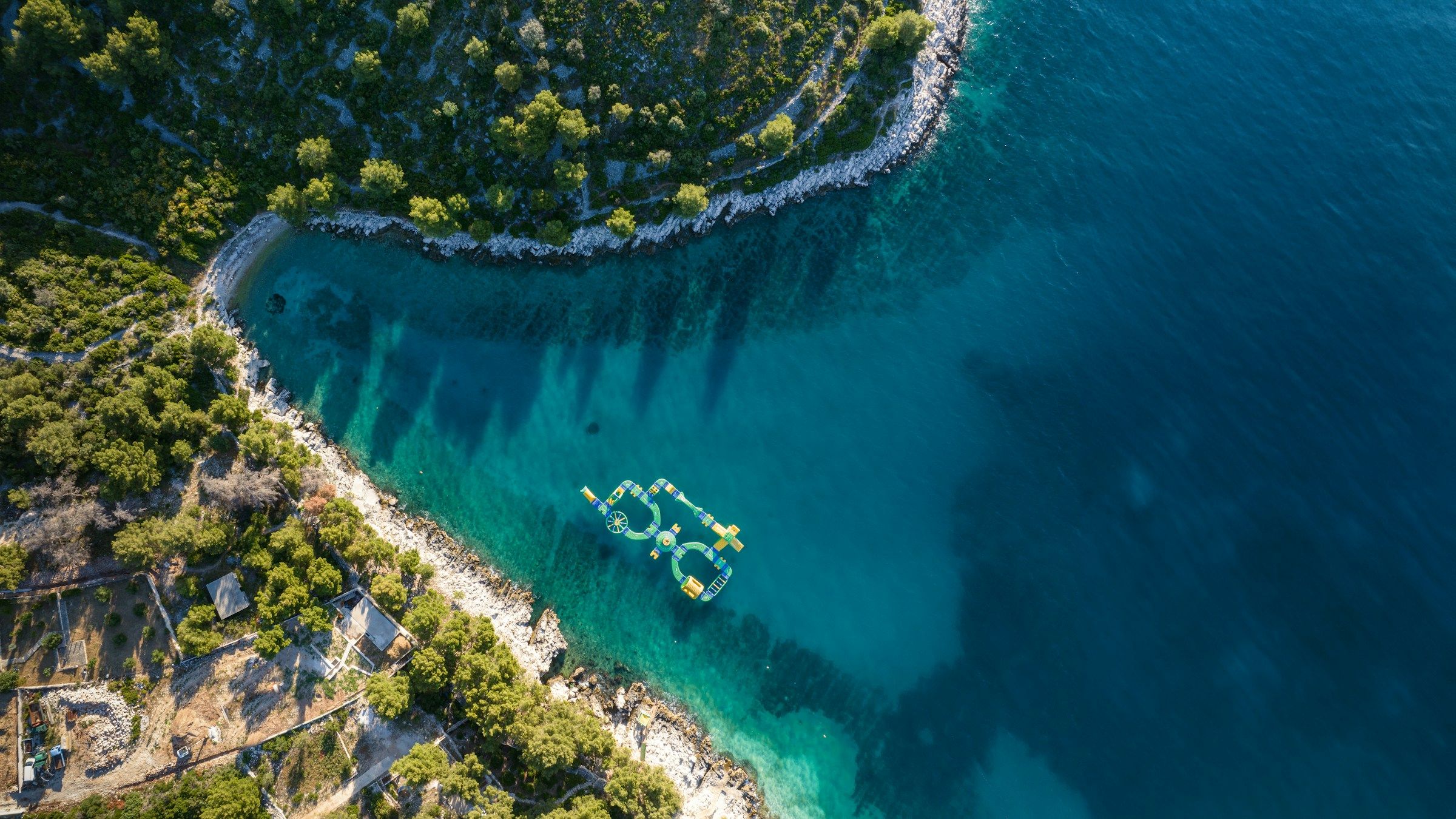 A boat crossing clear Adriatic water from above