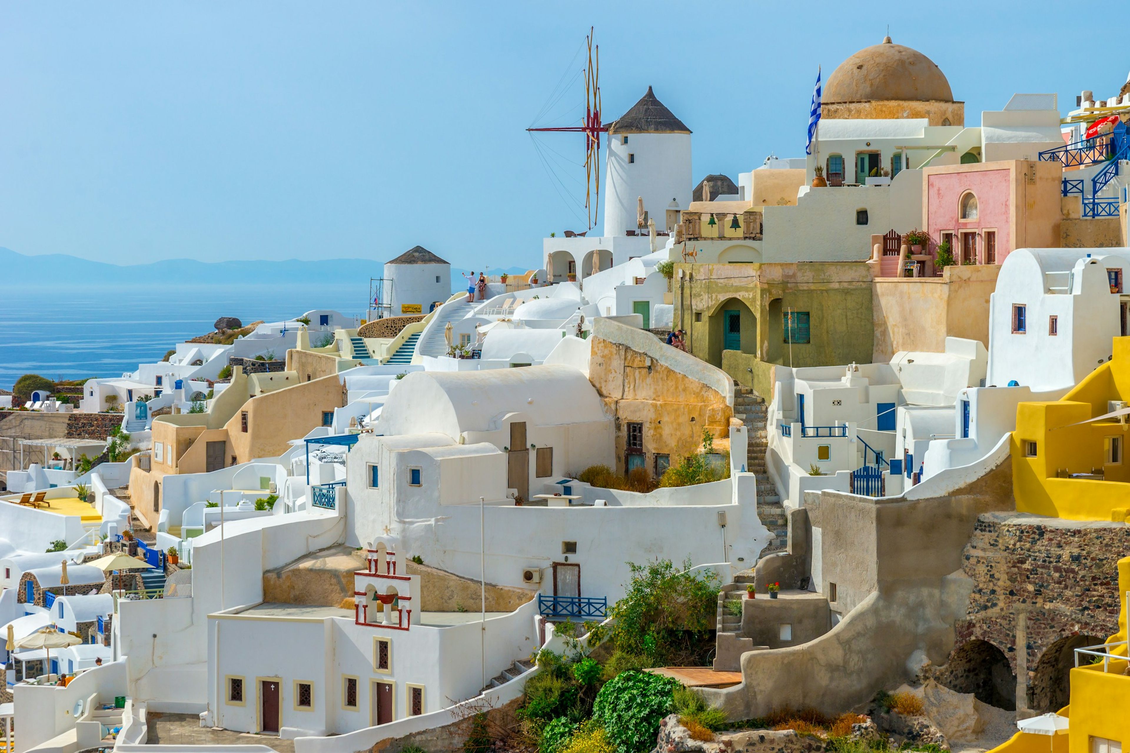 White village and windmills overlooking the sea