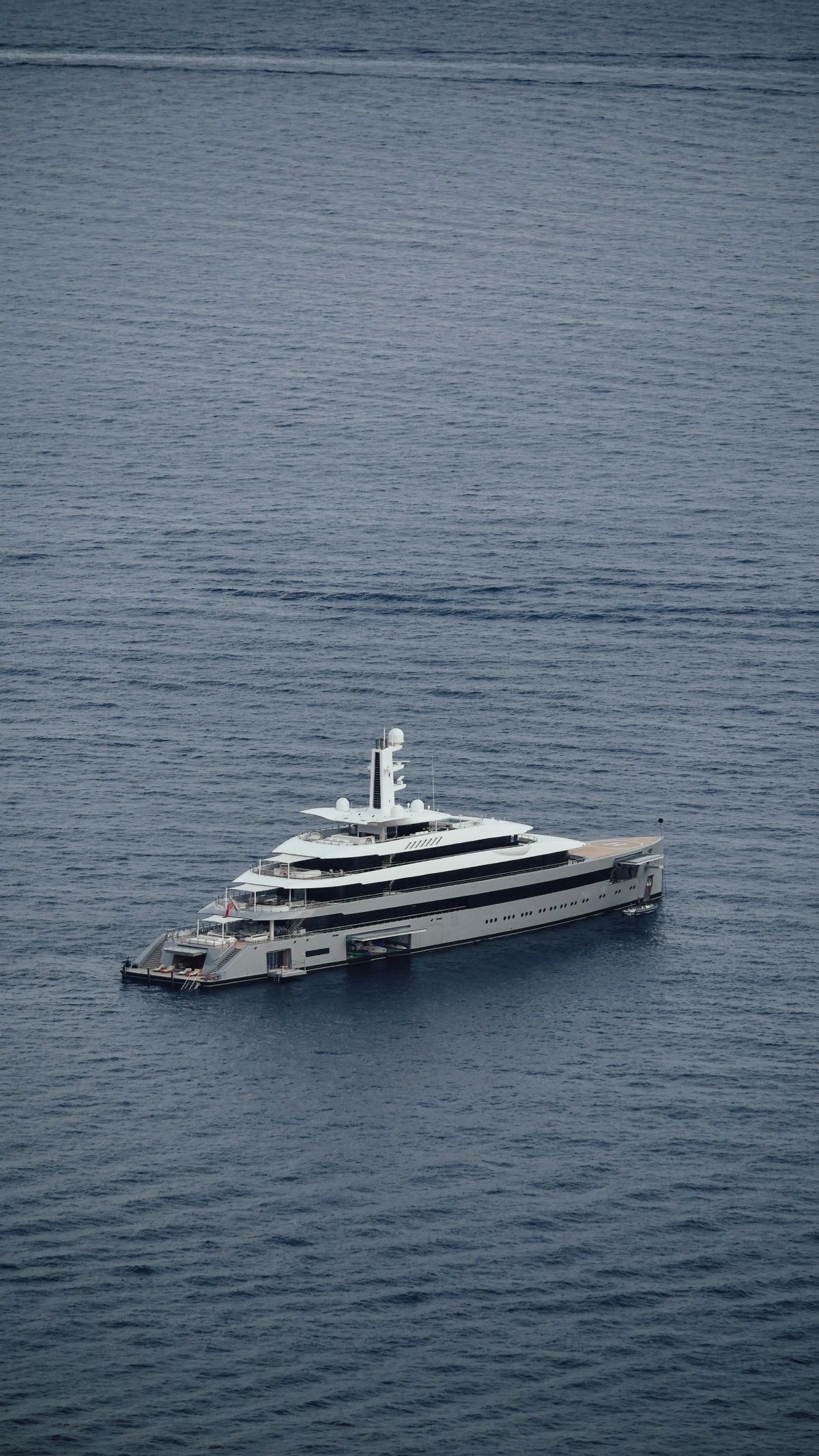A superyacht on calm grey water