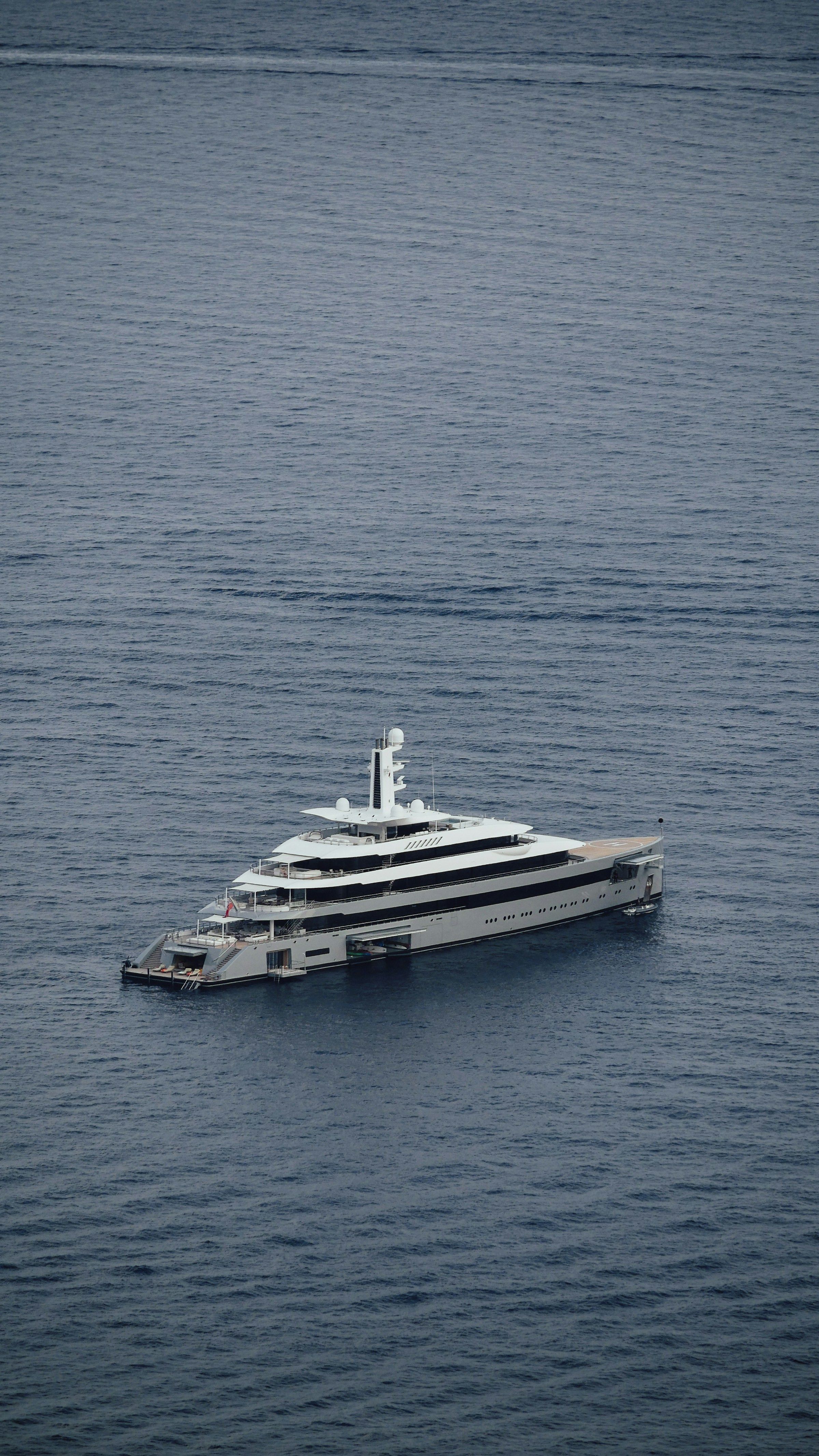 A superyacht on calm grey water
