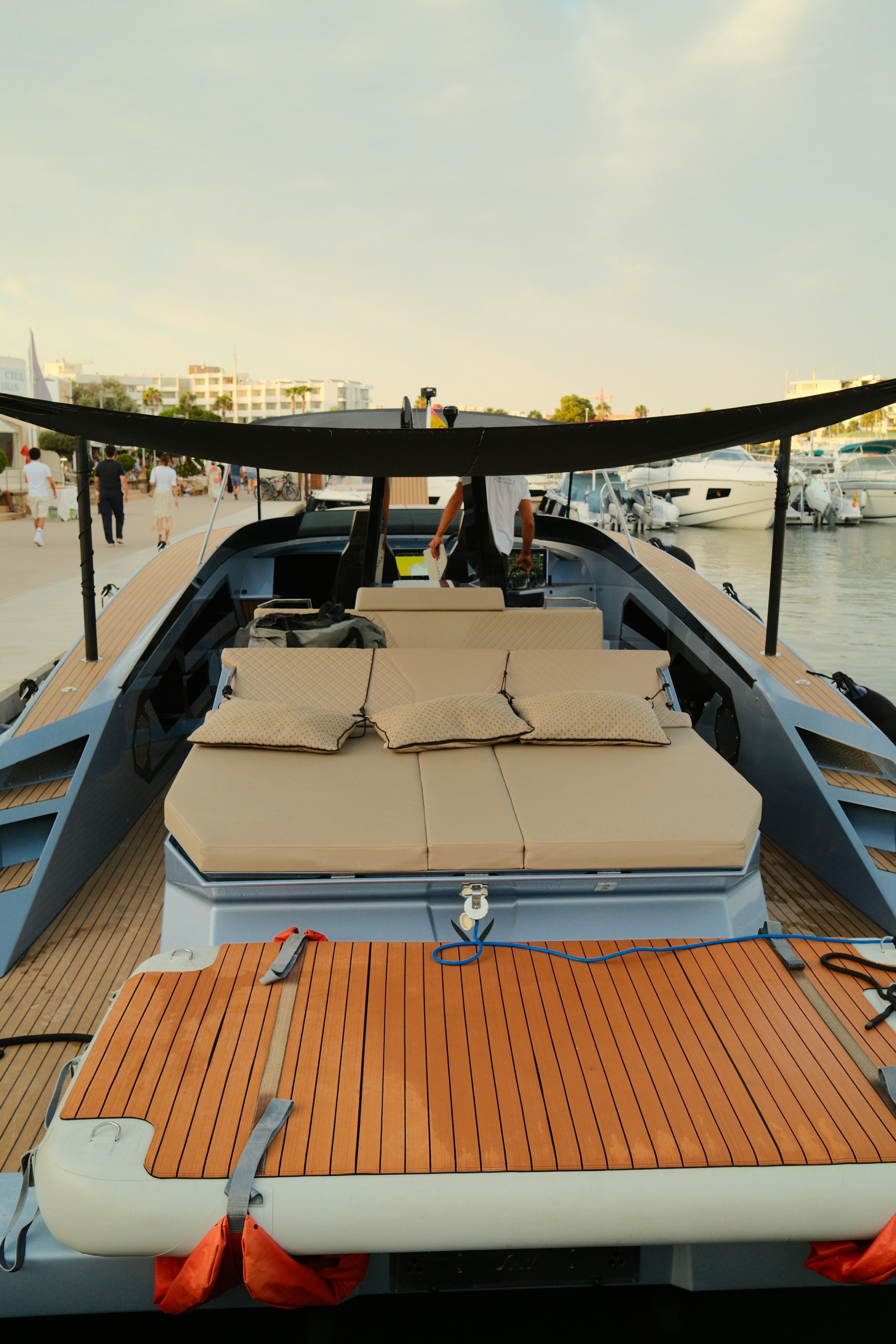 A teak sun deck with cushioned loungers