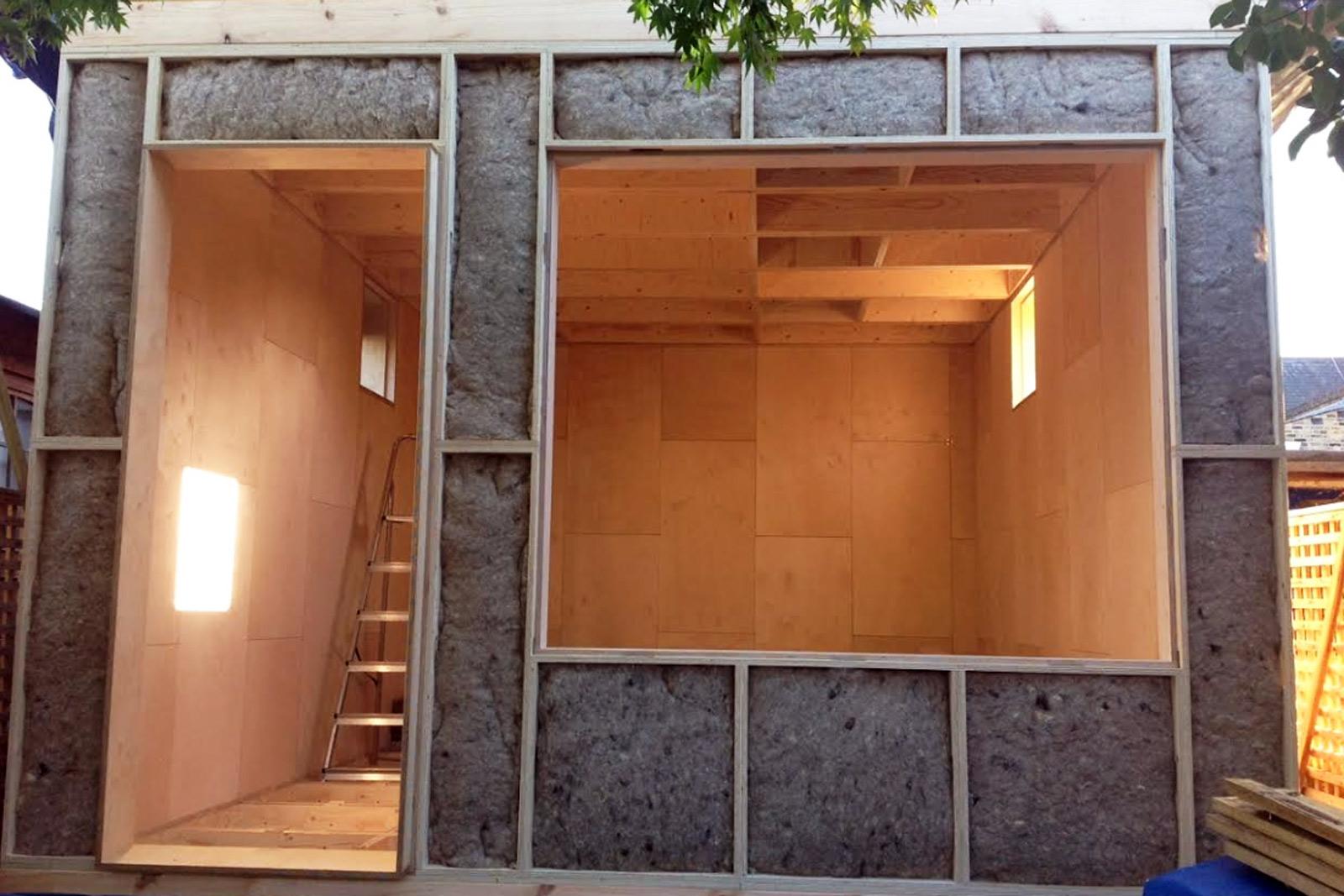 Front elevation of pod with exposed sheeps wool insulation inside U-Build wall boxes