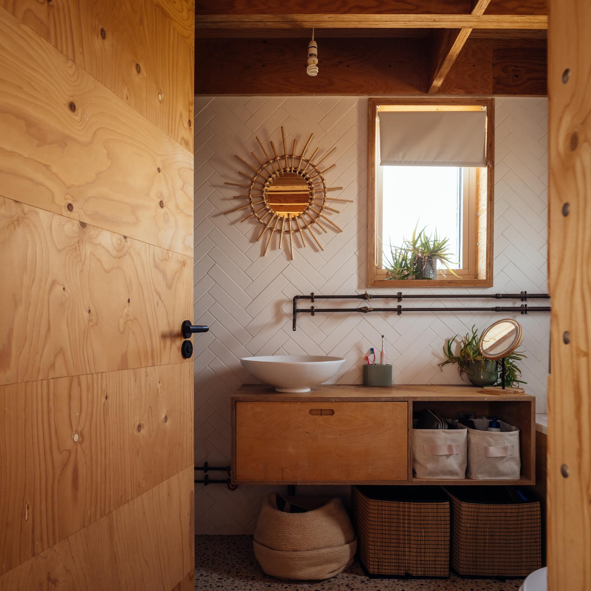 Family bathroom with exposed pipework to the taps
