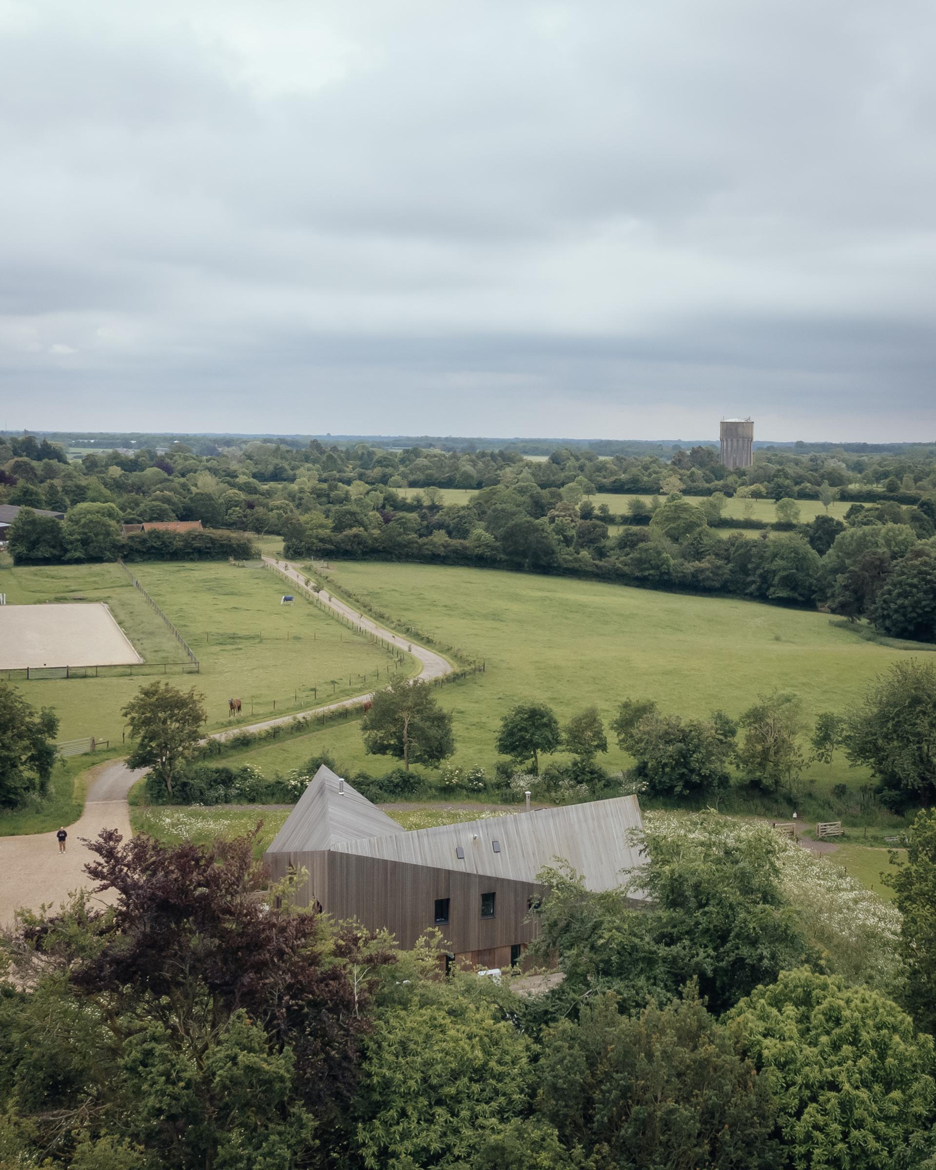 Water Farm, a HO11 Home is pictured from an aerial view in a rolling landscape