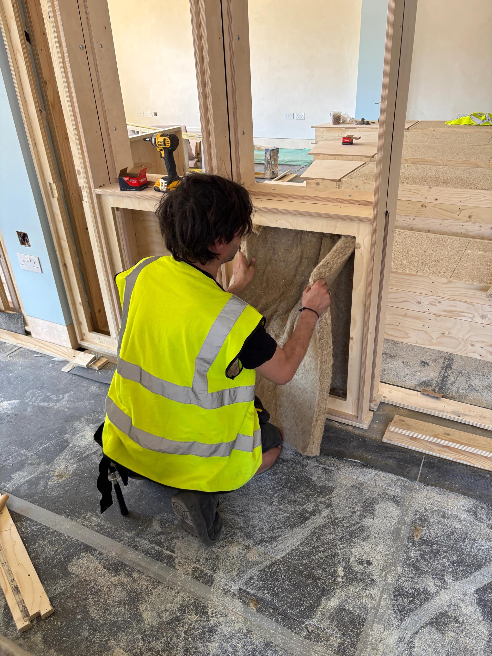 Acoustic insulation being inserted into a U-Build wall