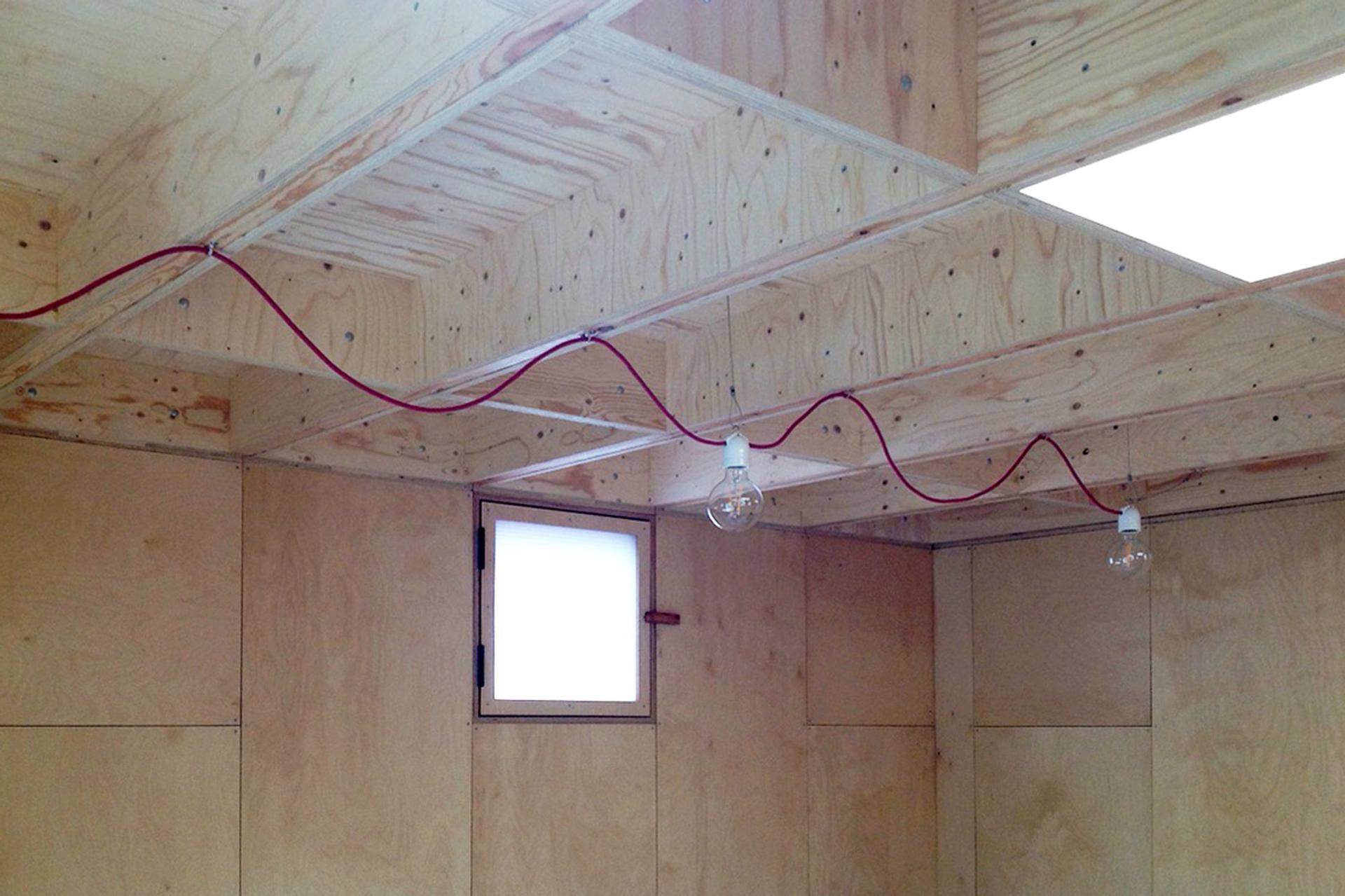 Lighting wires hang inside with an exposed undulating red wire