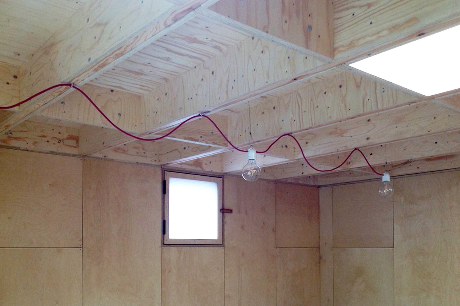 Lighting wires hang inside with an exposed undulating red wire