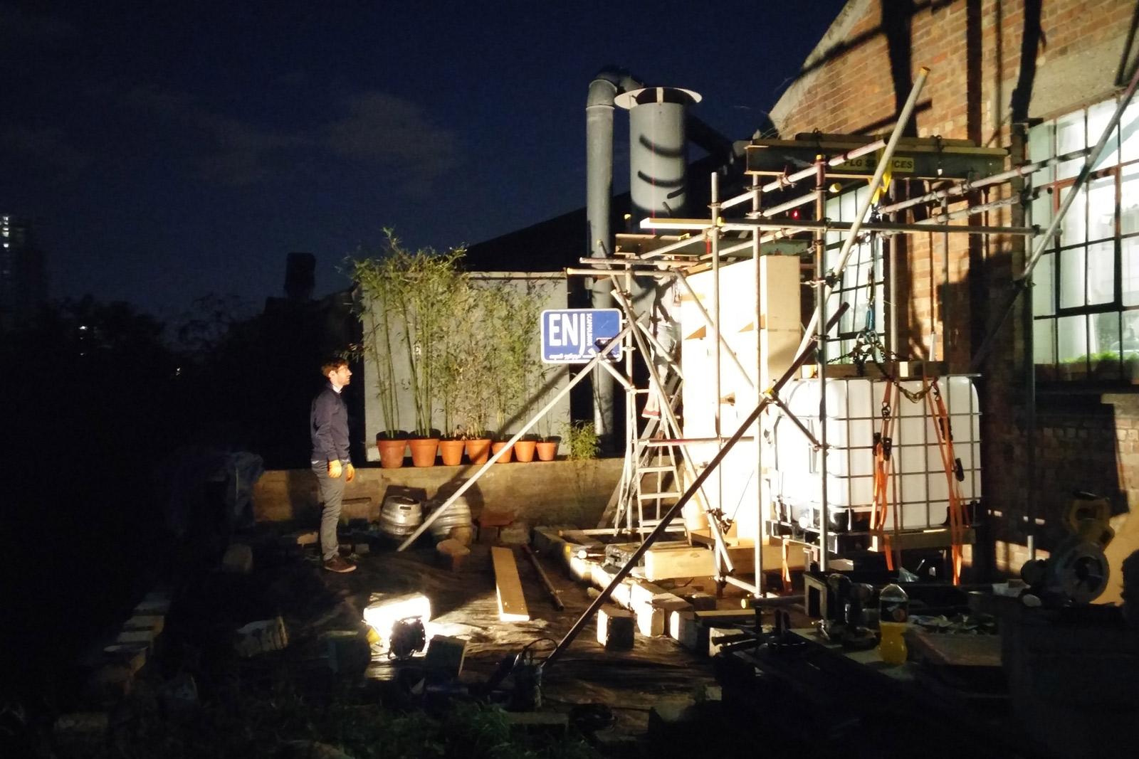 Box House in construction at night time