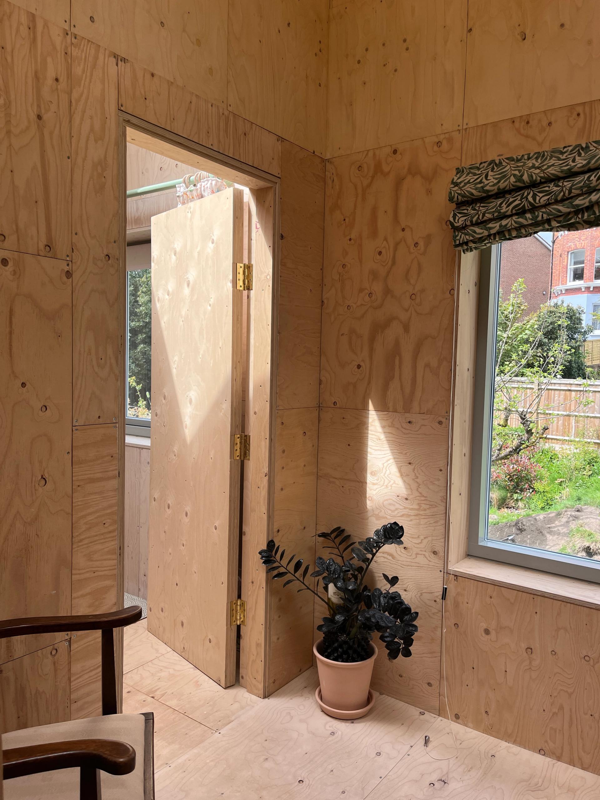 U-Build modern timber extension with large window and plant