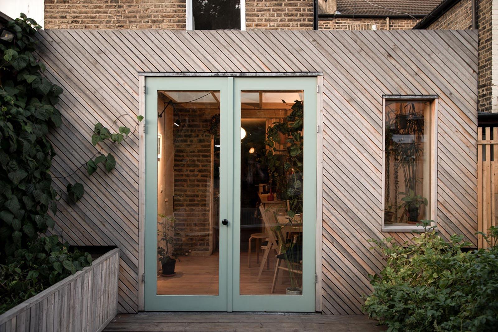 Extension of house made from diagonal timber slats