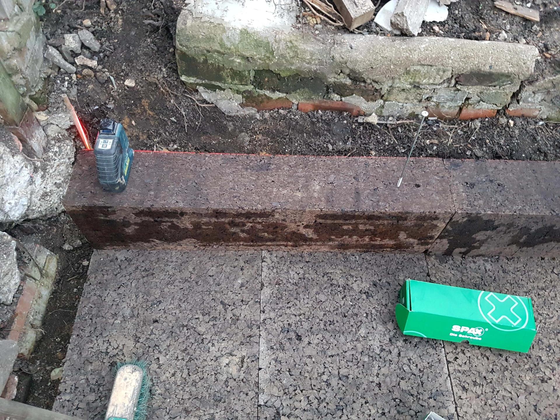Low cork plinth with long rods embedded within the wall