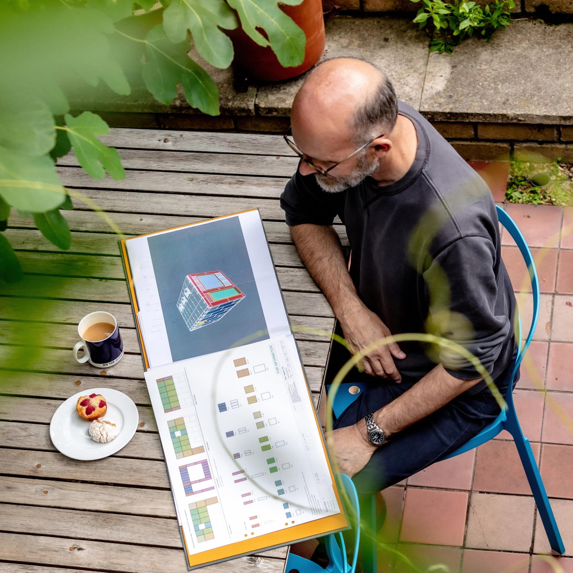 Image of client reading a design pack on coffee table