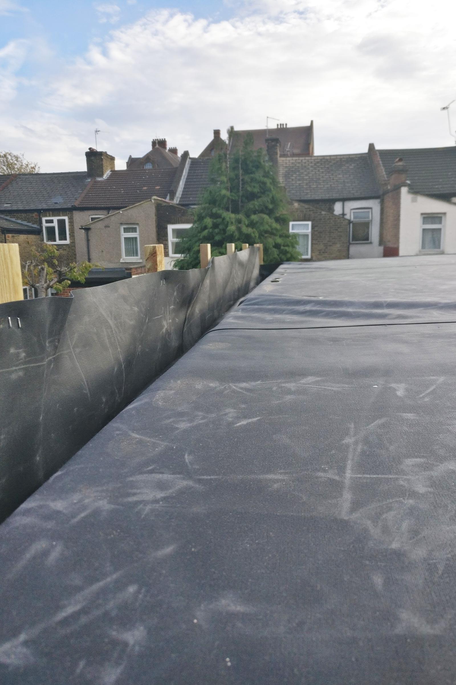 Battens prop up the black roof membrane