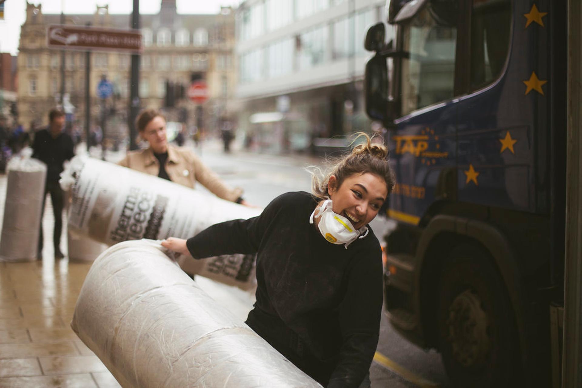 Thermafleece insulation rolls being transported by students
