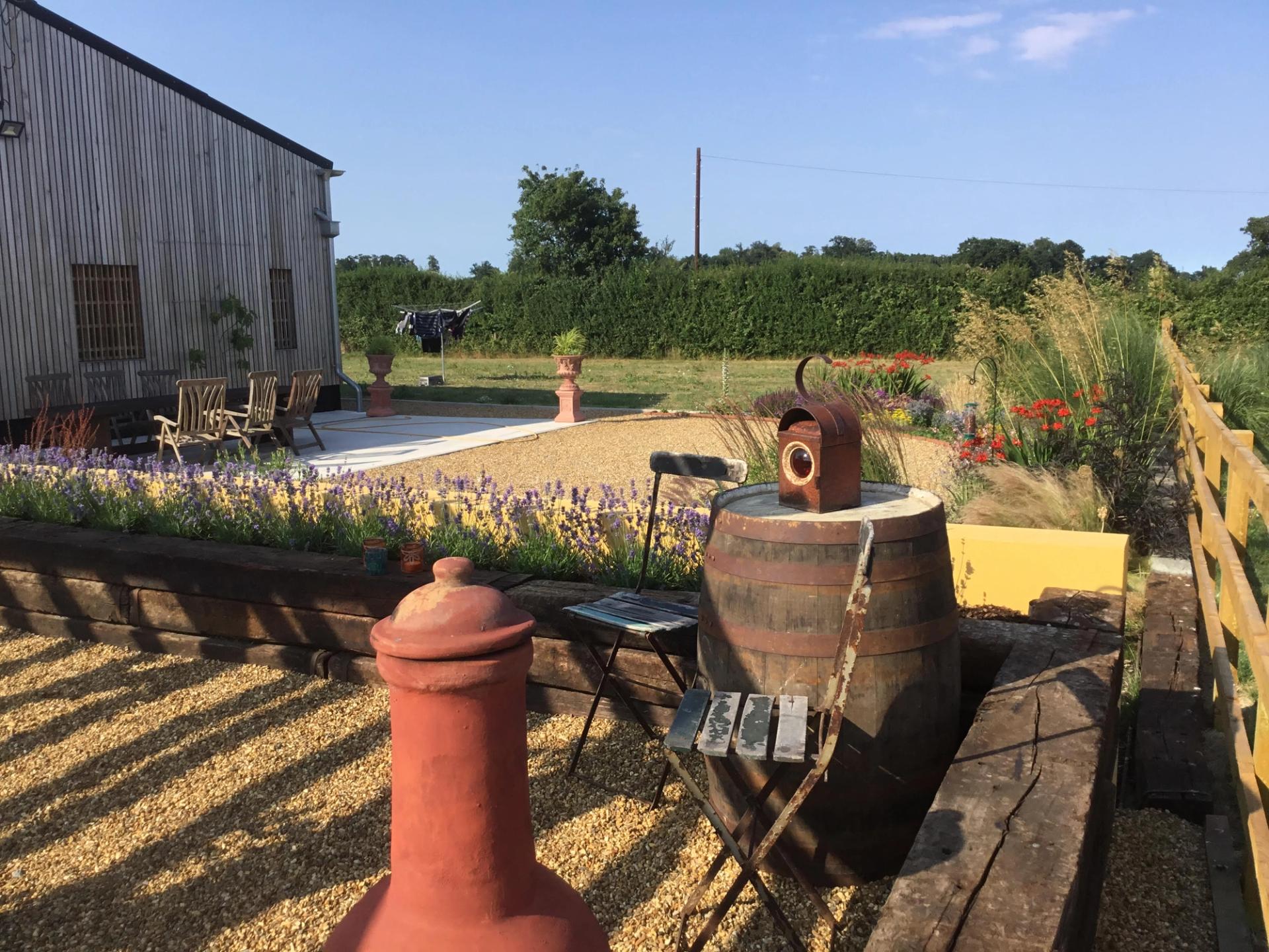 Exterior of Twin Barn Farm barn conversion by Studio Bark with outdoor living space