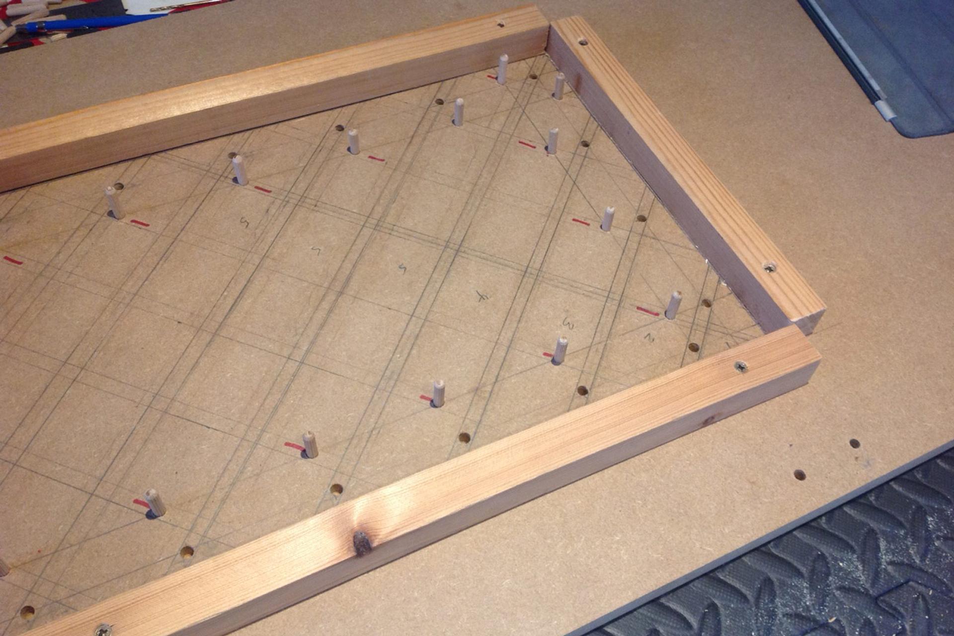 Timber framework marking out diagonal lines for timber cladding cutting
