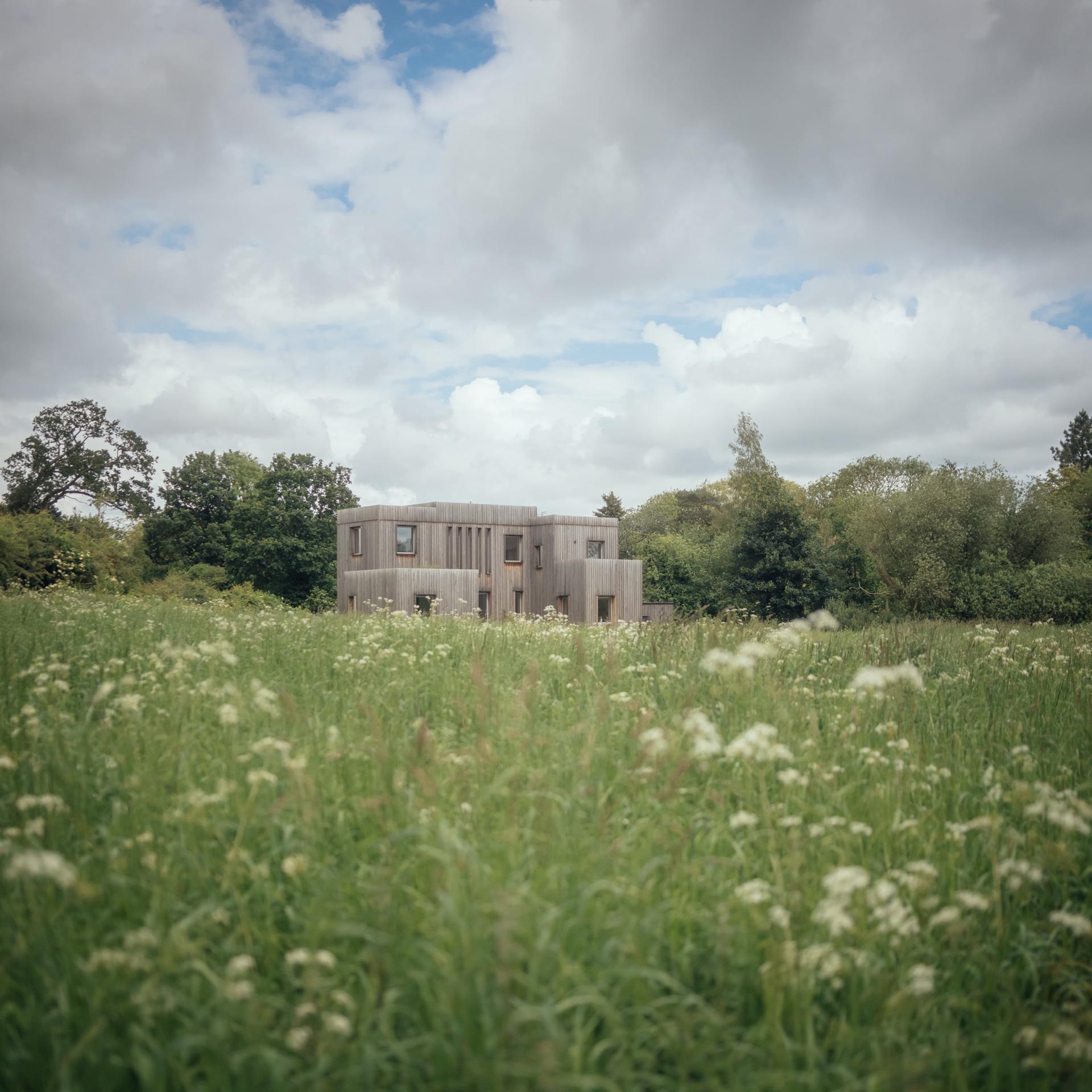 Timber home in the countryside with natural planting by Studio Bark