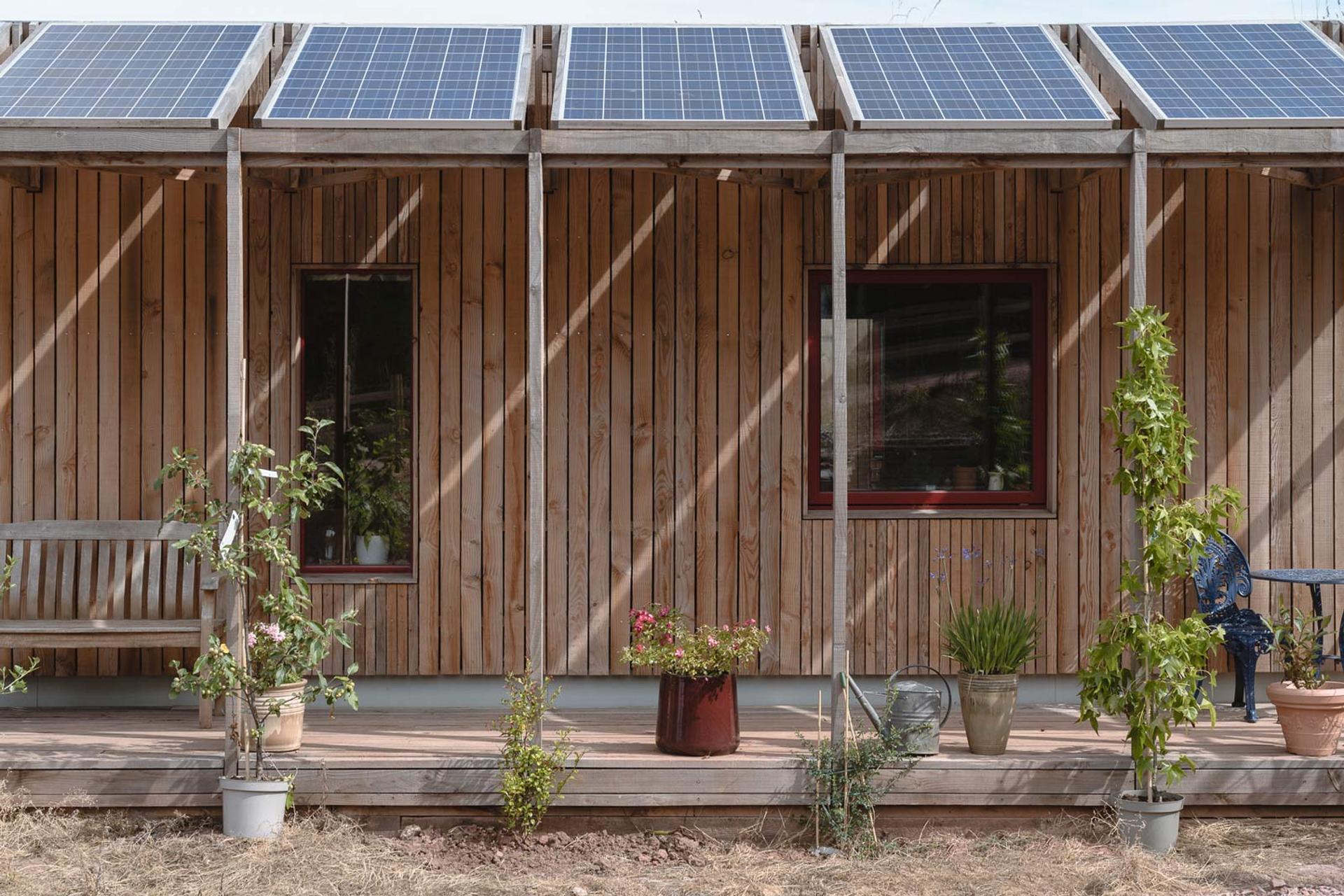 Timber home with solar panel terrace and landscaping