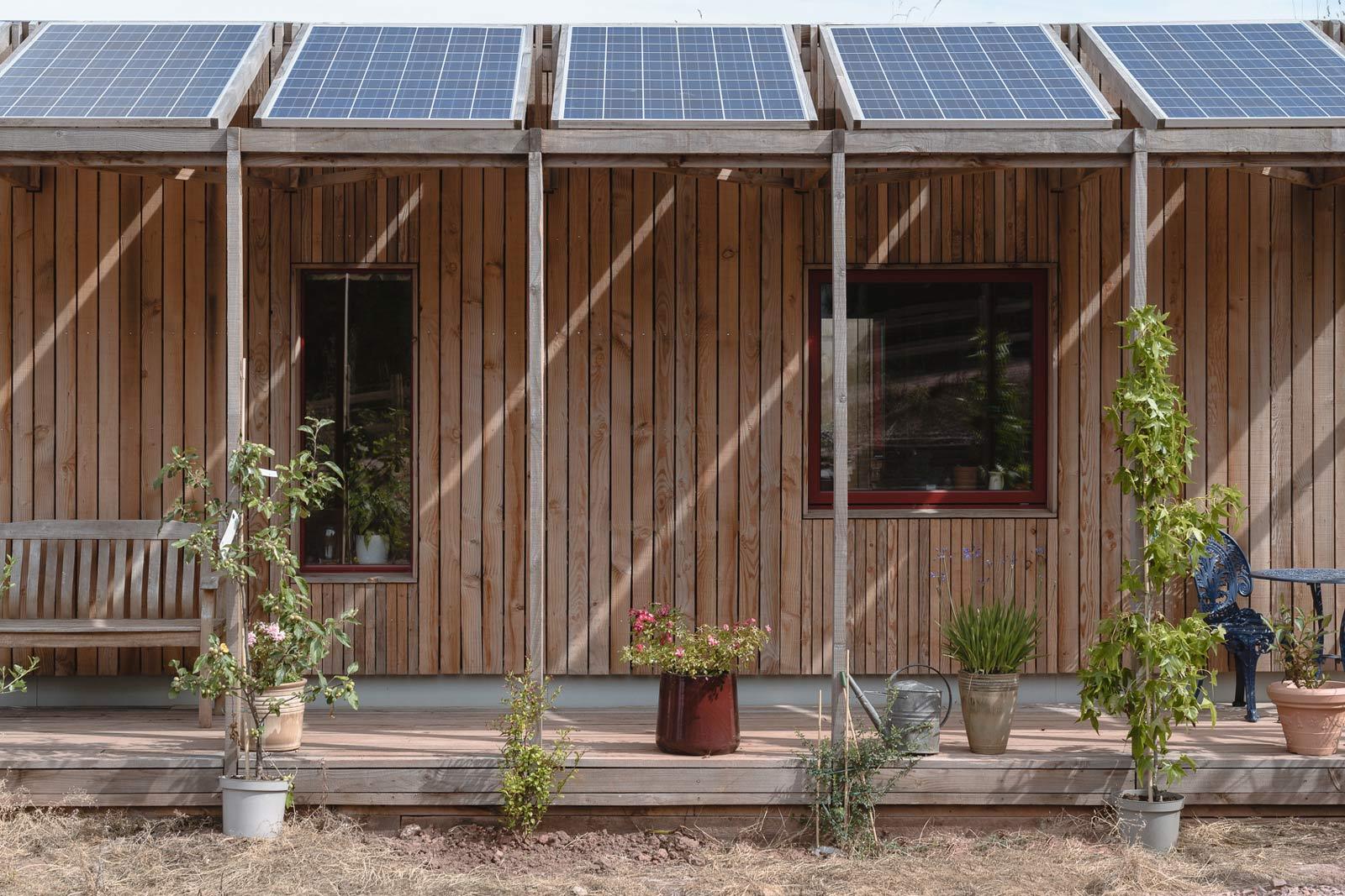 Timber home with solar panel terrace and landscaping