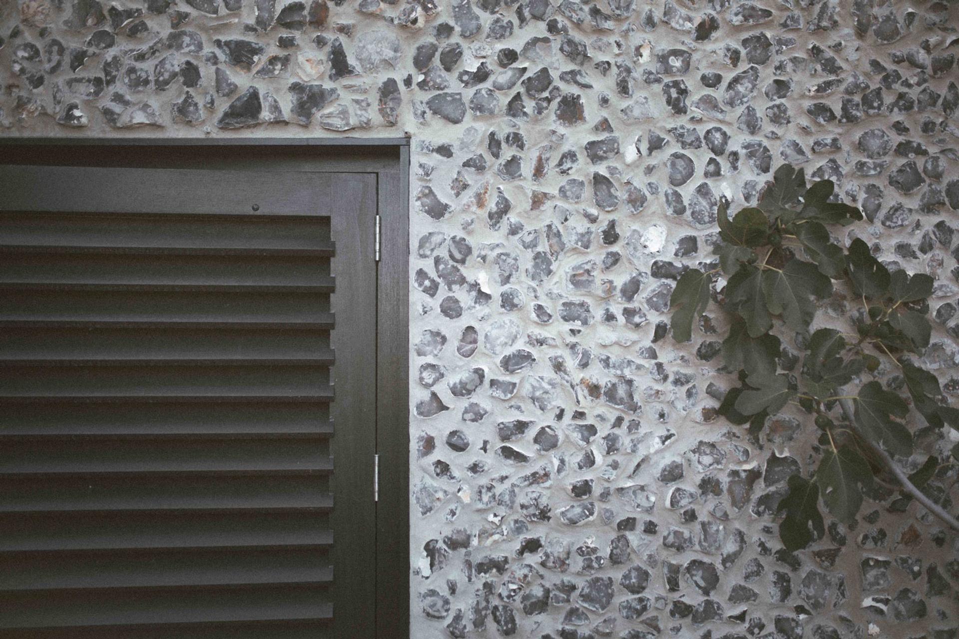 Detail of a new build family home with flint and timber