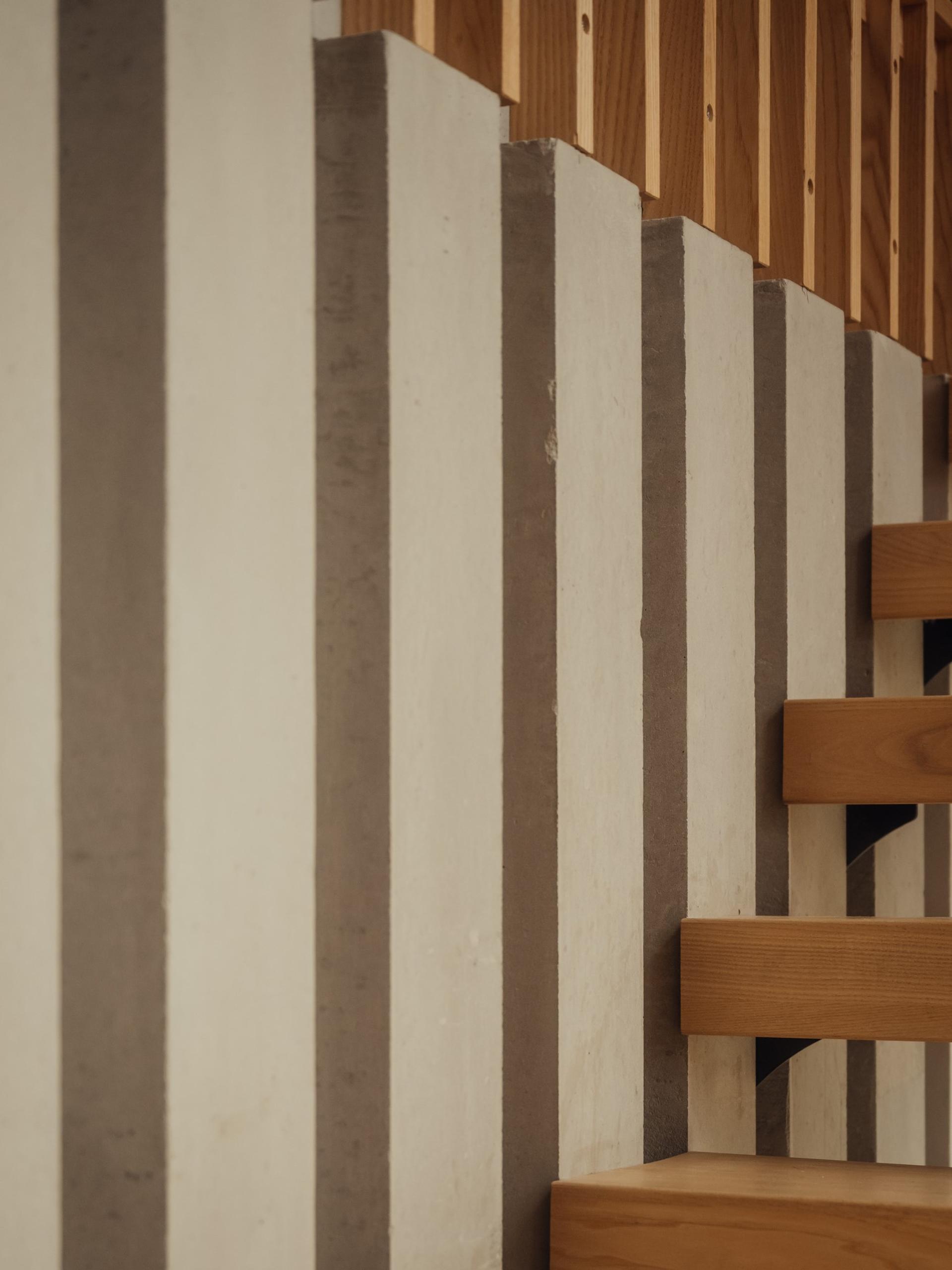 Orchard House by Studio Bark interior view - concrete and timber stair