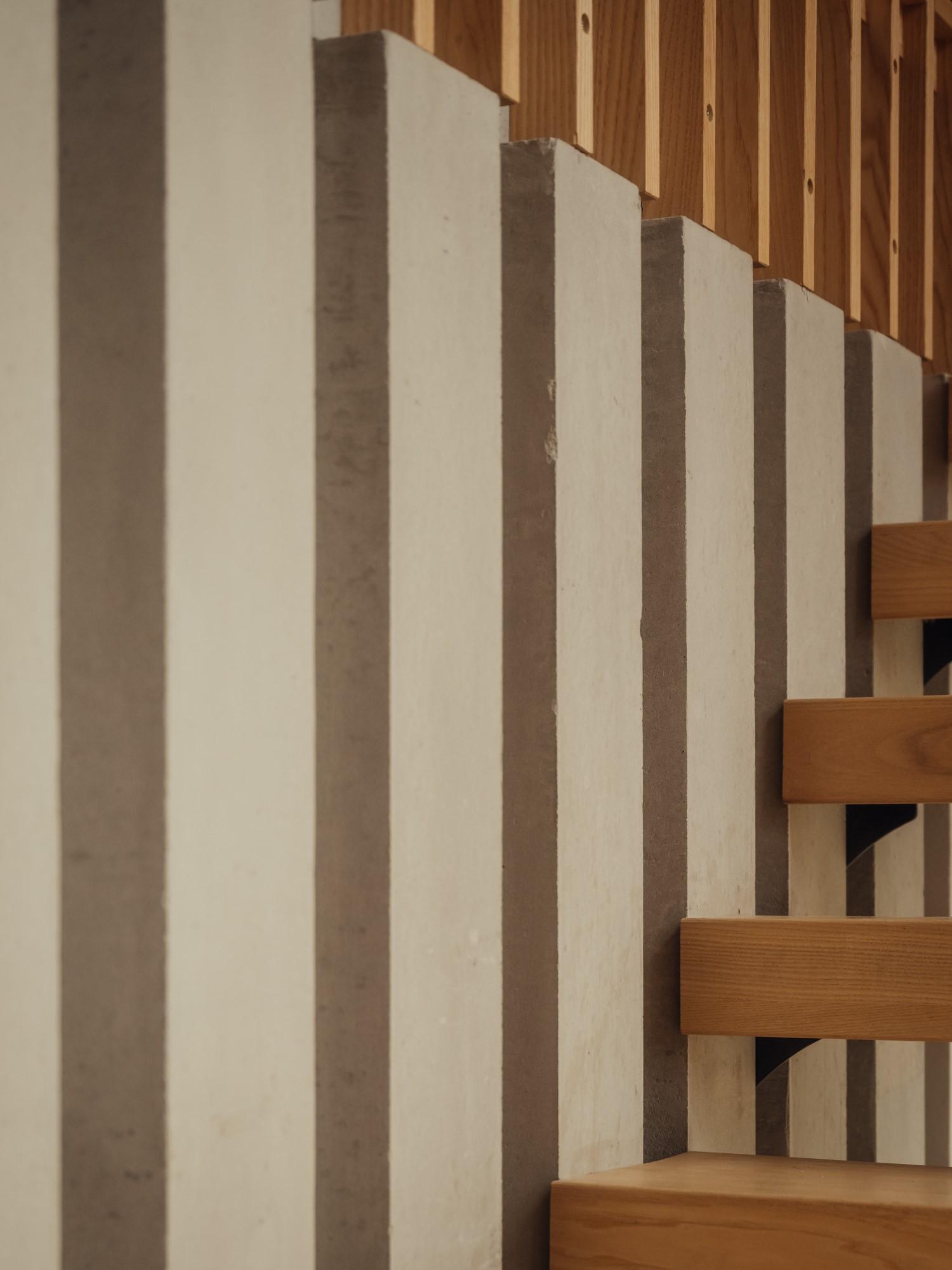 Orchard House by Studio Bark interior view - concrete and timber stair