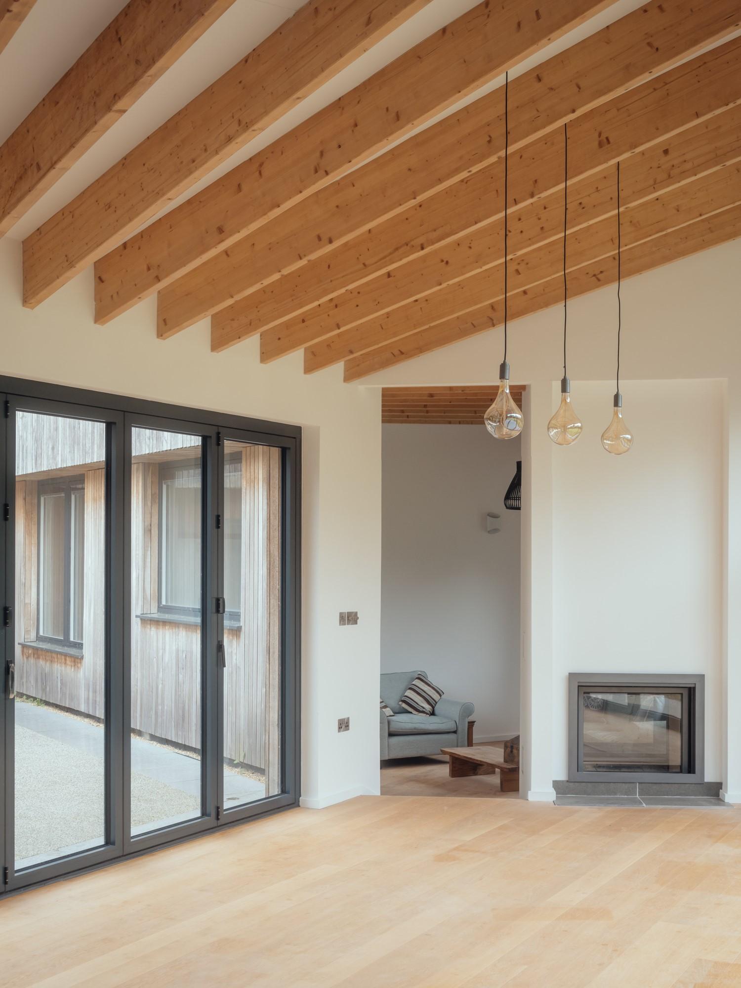 Contemporary living room with exposed beams by Studio Bark