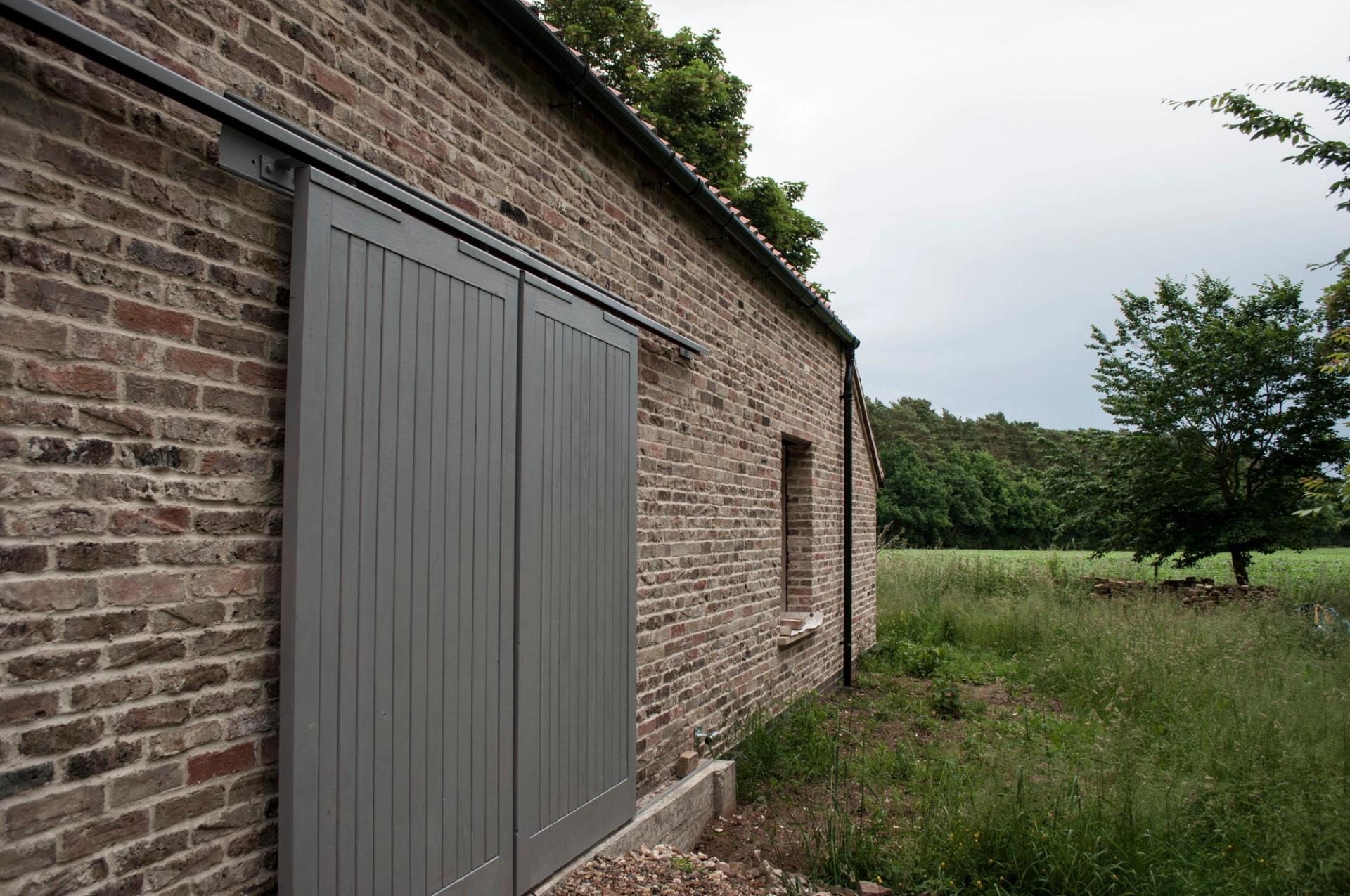 Barn door and traditional materials at Warren Lodge