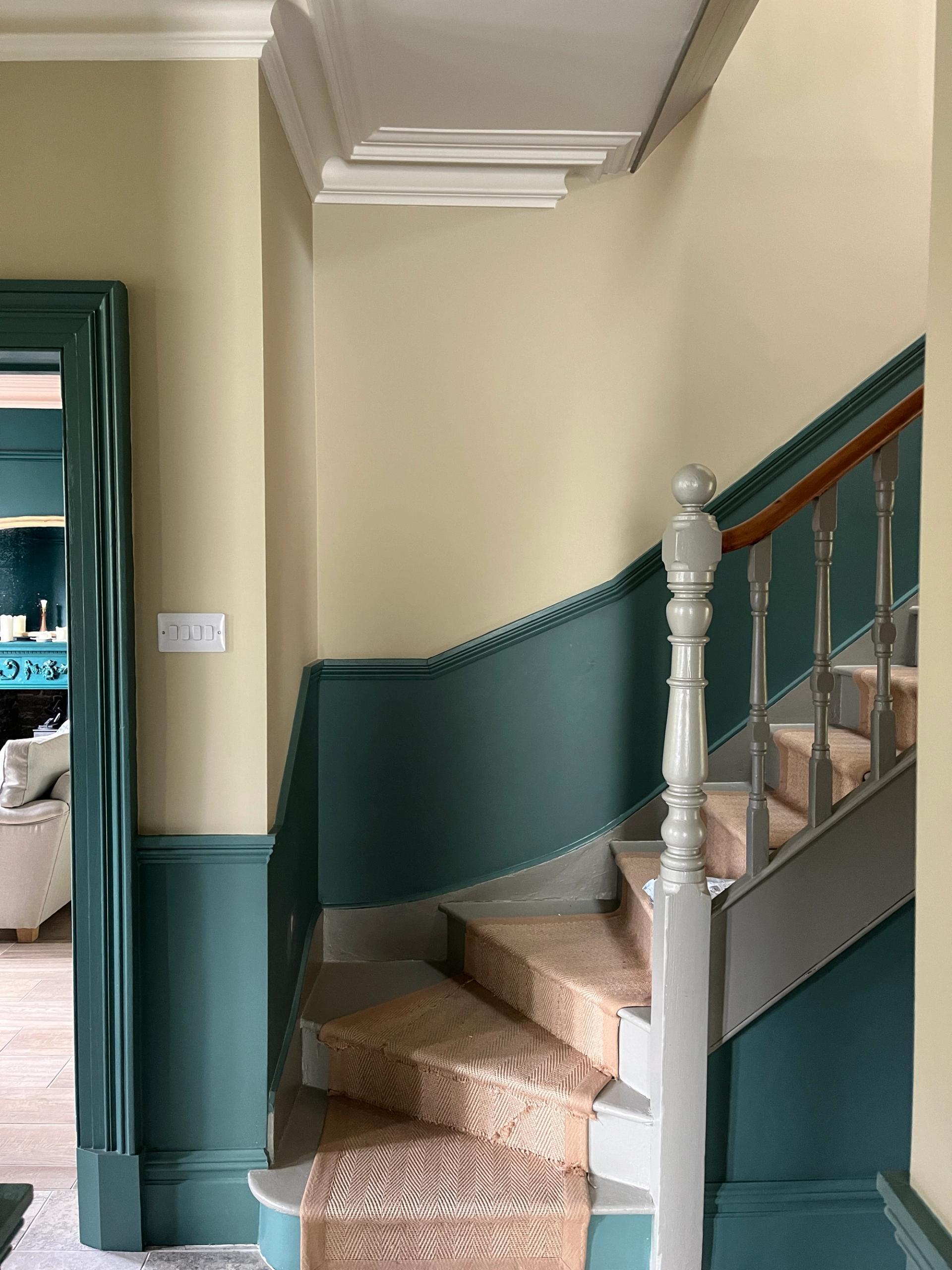 Victorian staircase with teal and cream walls