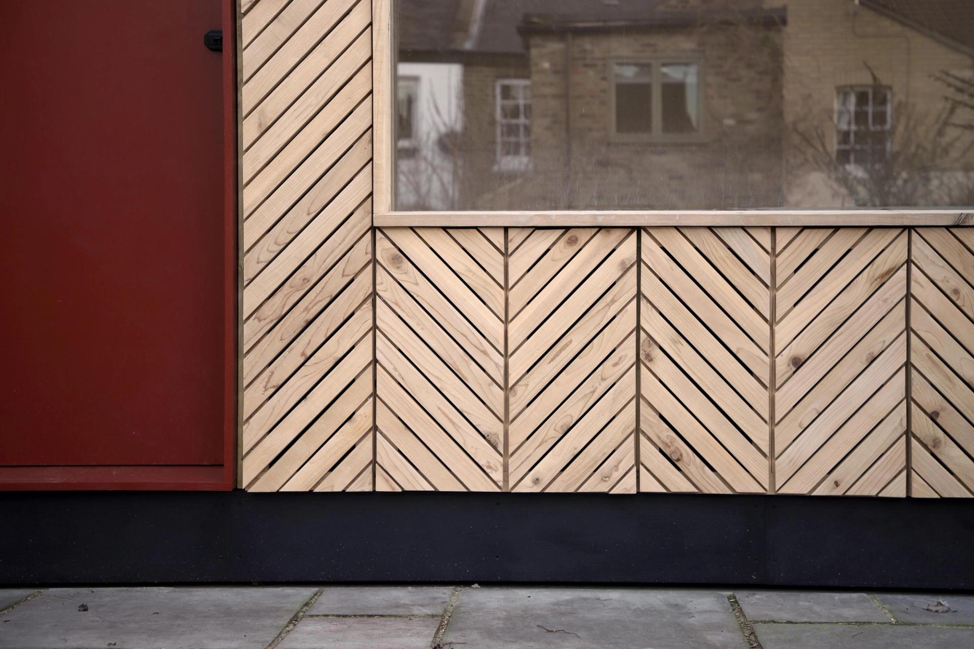 View of diagonal timber slat patterns that make up garden shed cladding