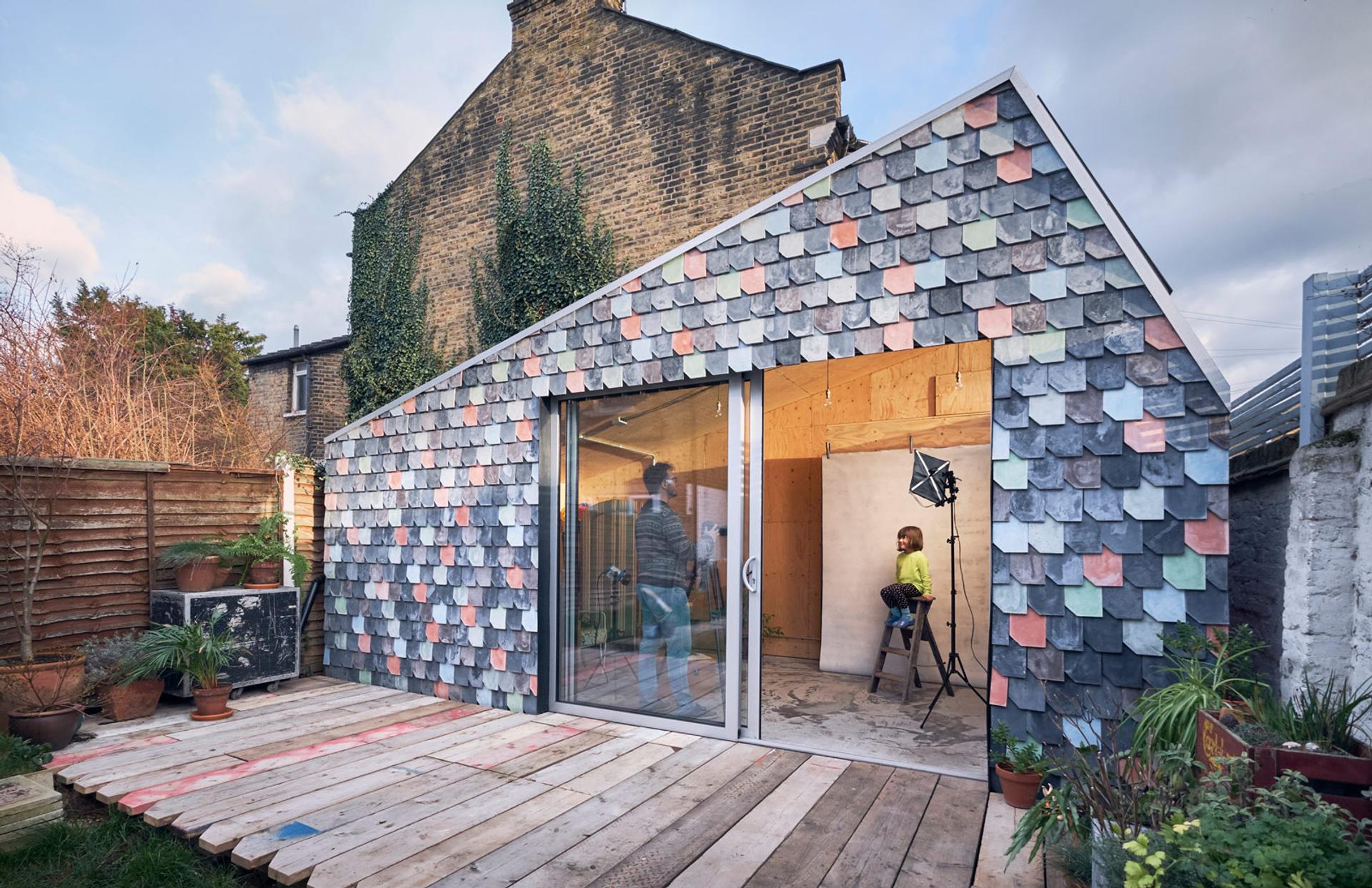 Handmade tiles clad the exterior of a garden studio in London