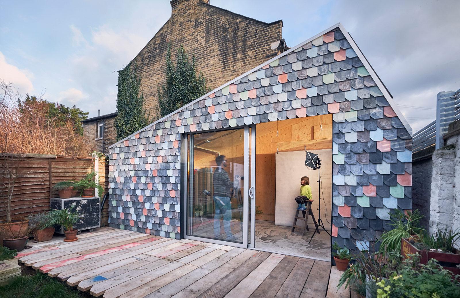 Handmade tiles clad the exterior of a garden studio in London