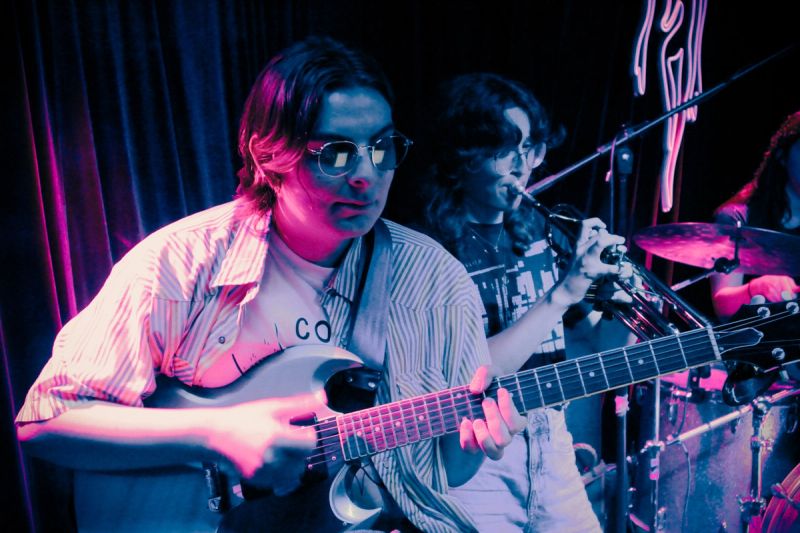 Two jammers; person playing guitar, person playing trumpet.