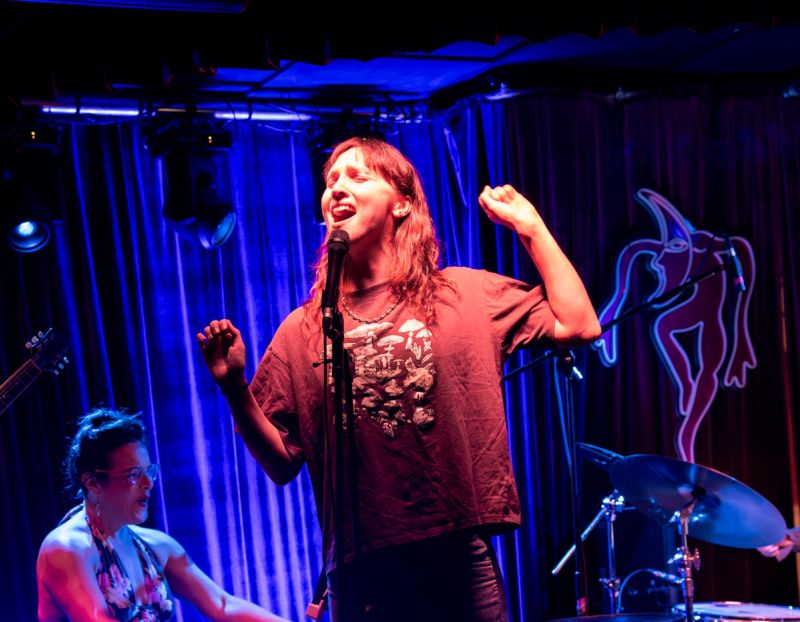 jammer singing with eyes closed, arms out expressively