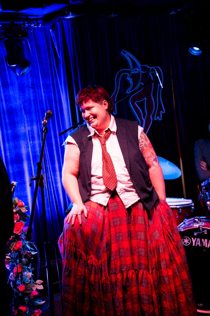 'Nead sitting on stage smiling