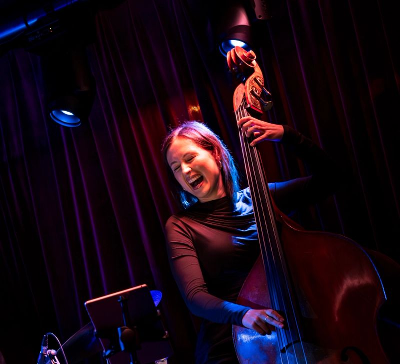 bass player playing while smiling