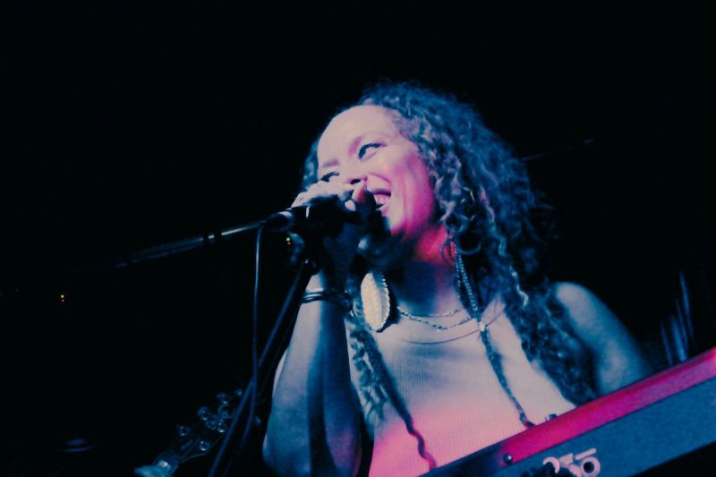 la gati, holding microphone, smiling
